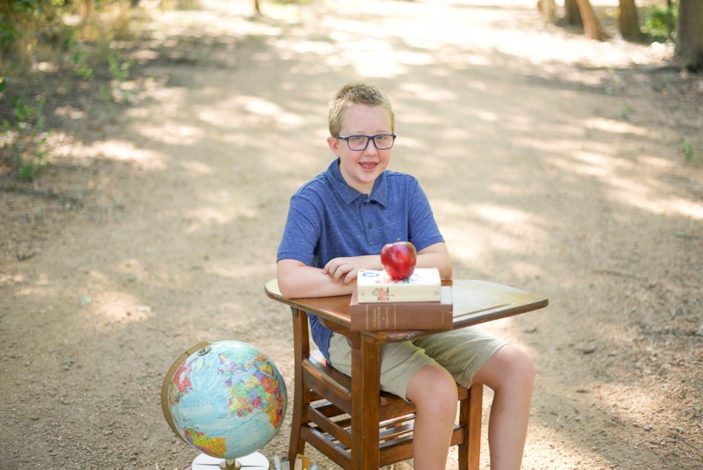 boy sits at desk in Beard Park during Back to School Mini Sessions