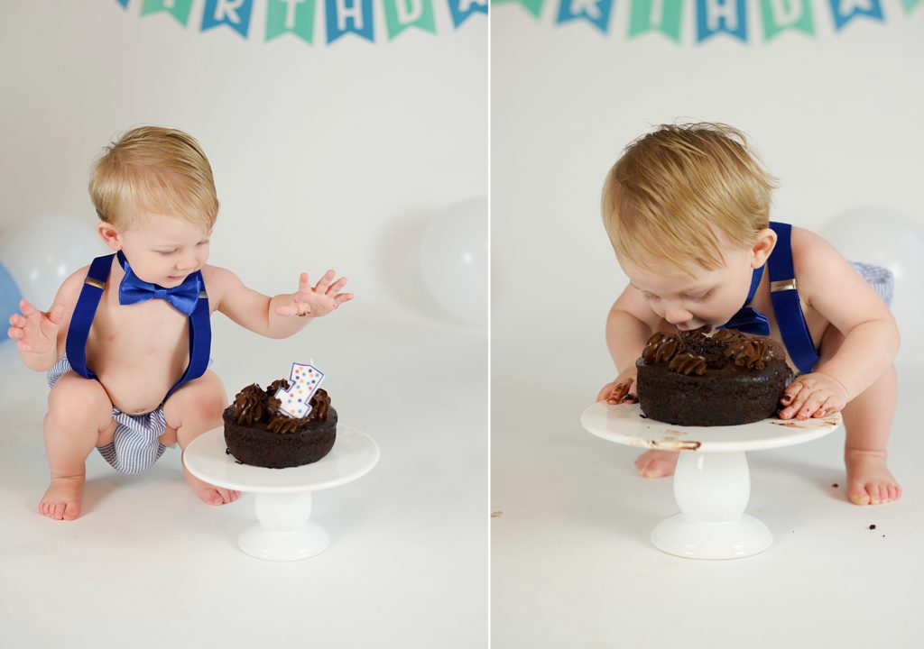 toddler plays with cake during first birthday cake smash