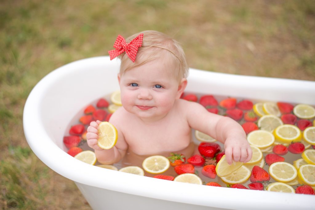 Texas milestone photos of little girl in fruit bath of strawberries and lemons