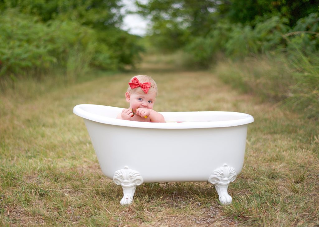 baby girl sits in tub during Texas milestone photos