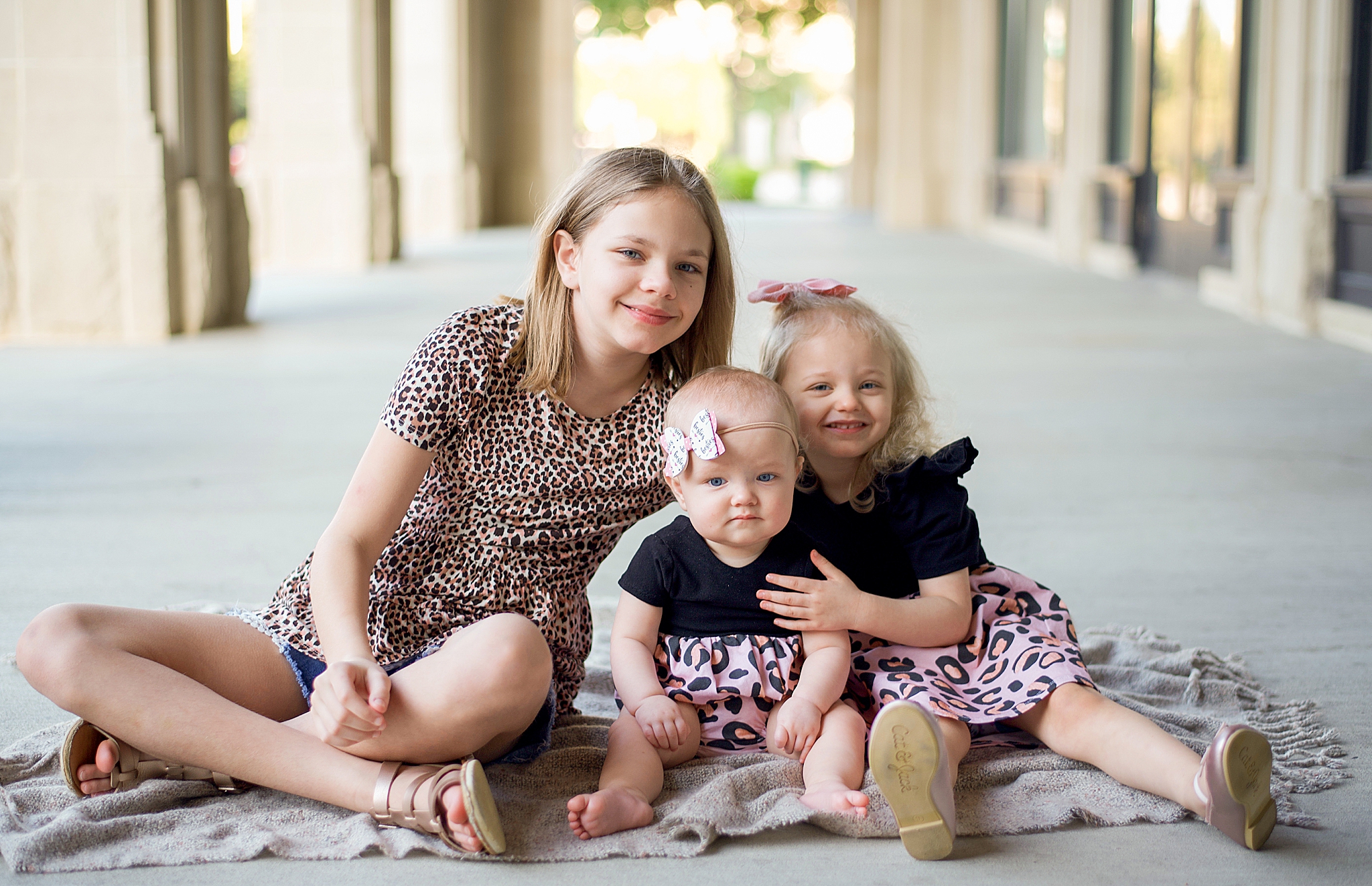 sisters pose during Frisco Square family portraits