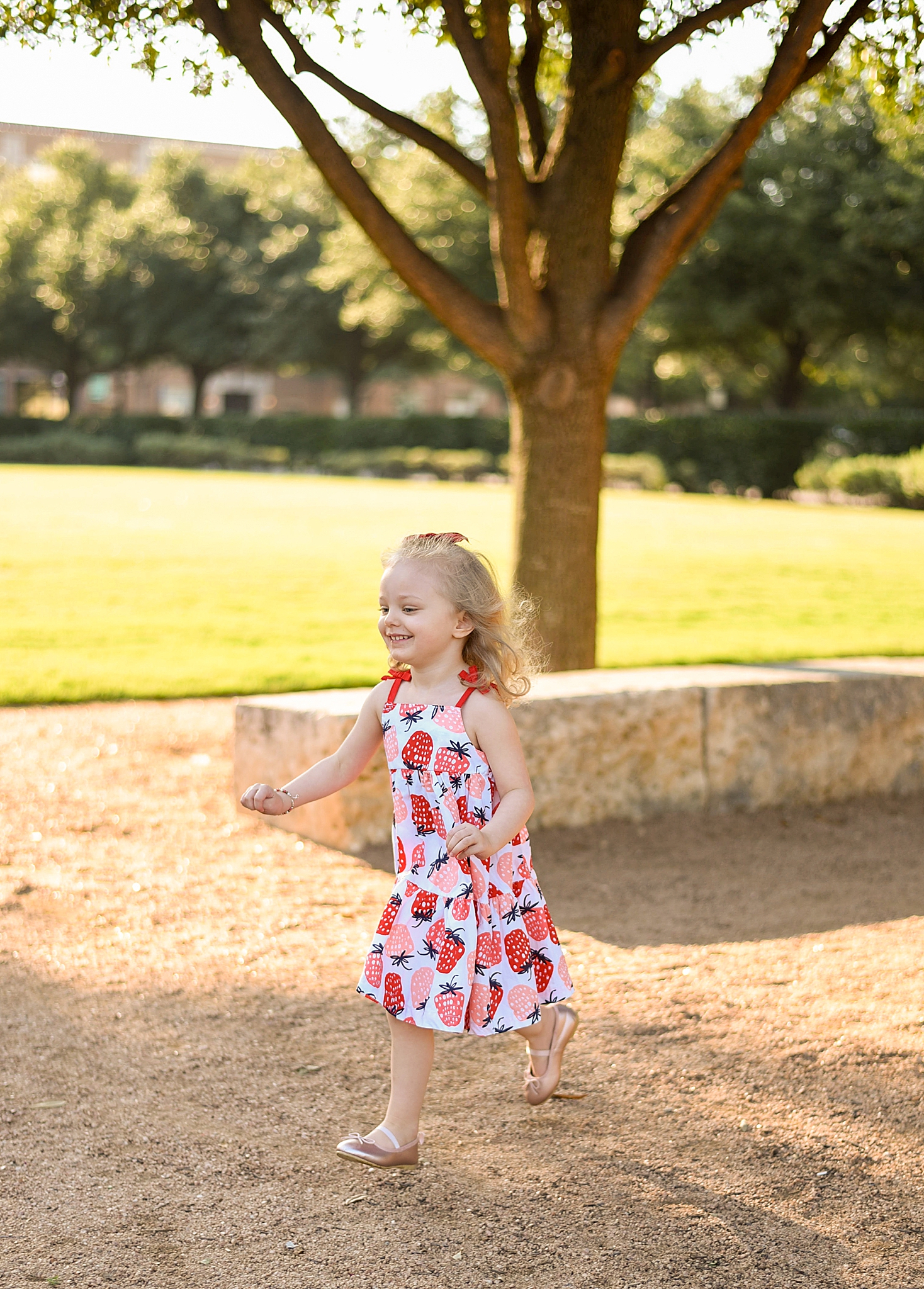 little girl runs around playground during Frisco Square family portraits