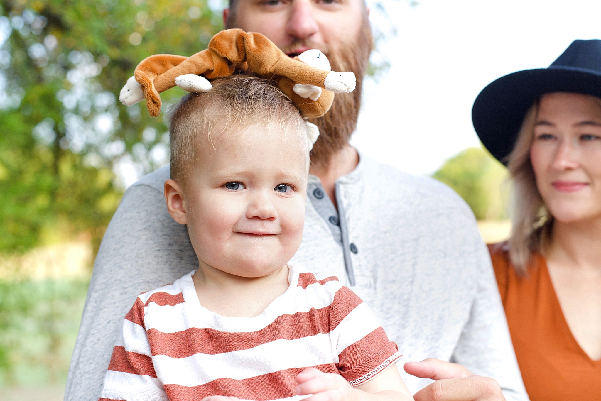 toddler poses with stuffed animal on head during Little Elm family portraits