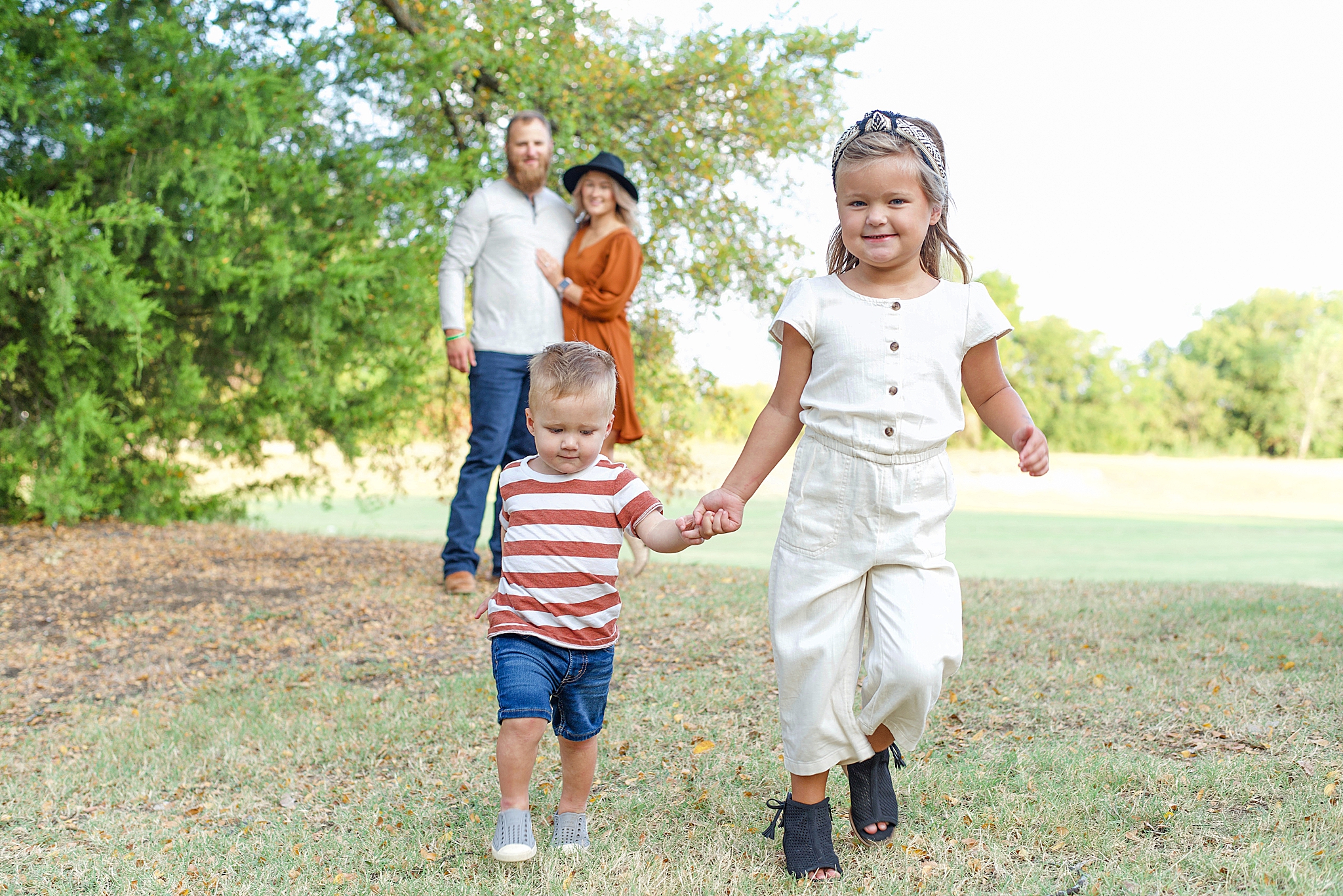 kids run in front of parents during family photos in Texas