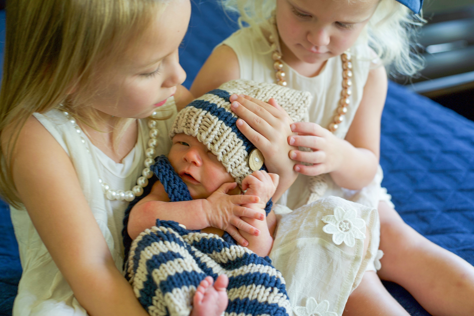 Little Elm Lifestyle Newborn Session with baby in blue and white knit outfit