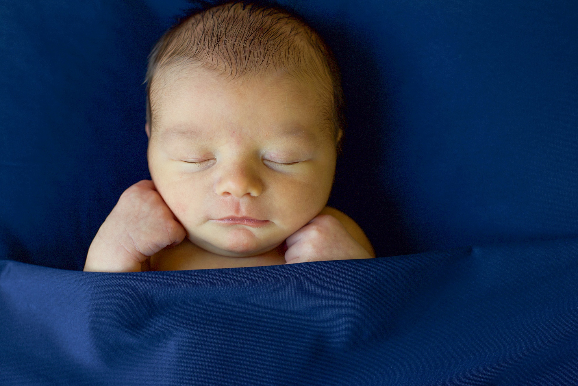 baby sleeps in blue sheet during Little Elm Lifestyle Newborn Session