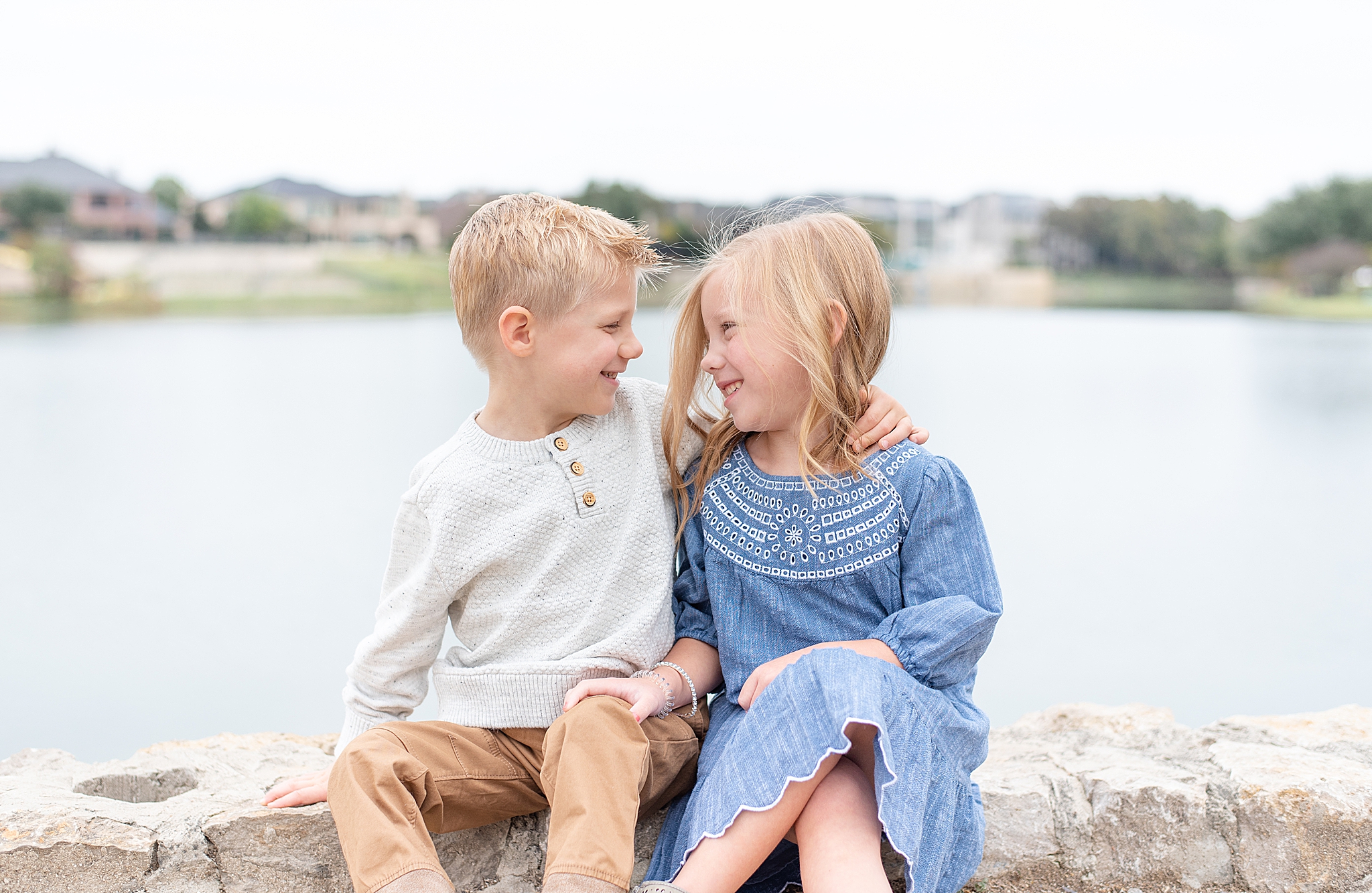 siblings pose by McKinney TX waterfront