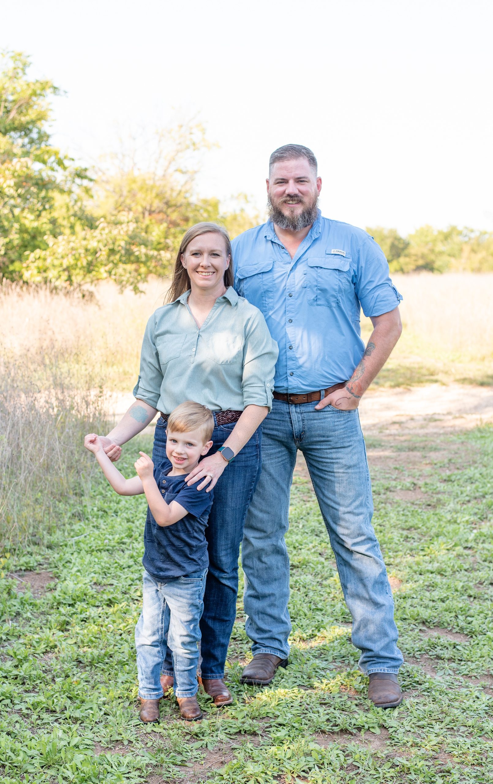 parents pose with son during Frisco Commons Park family portraits