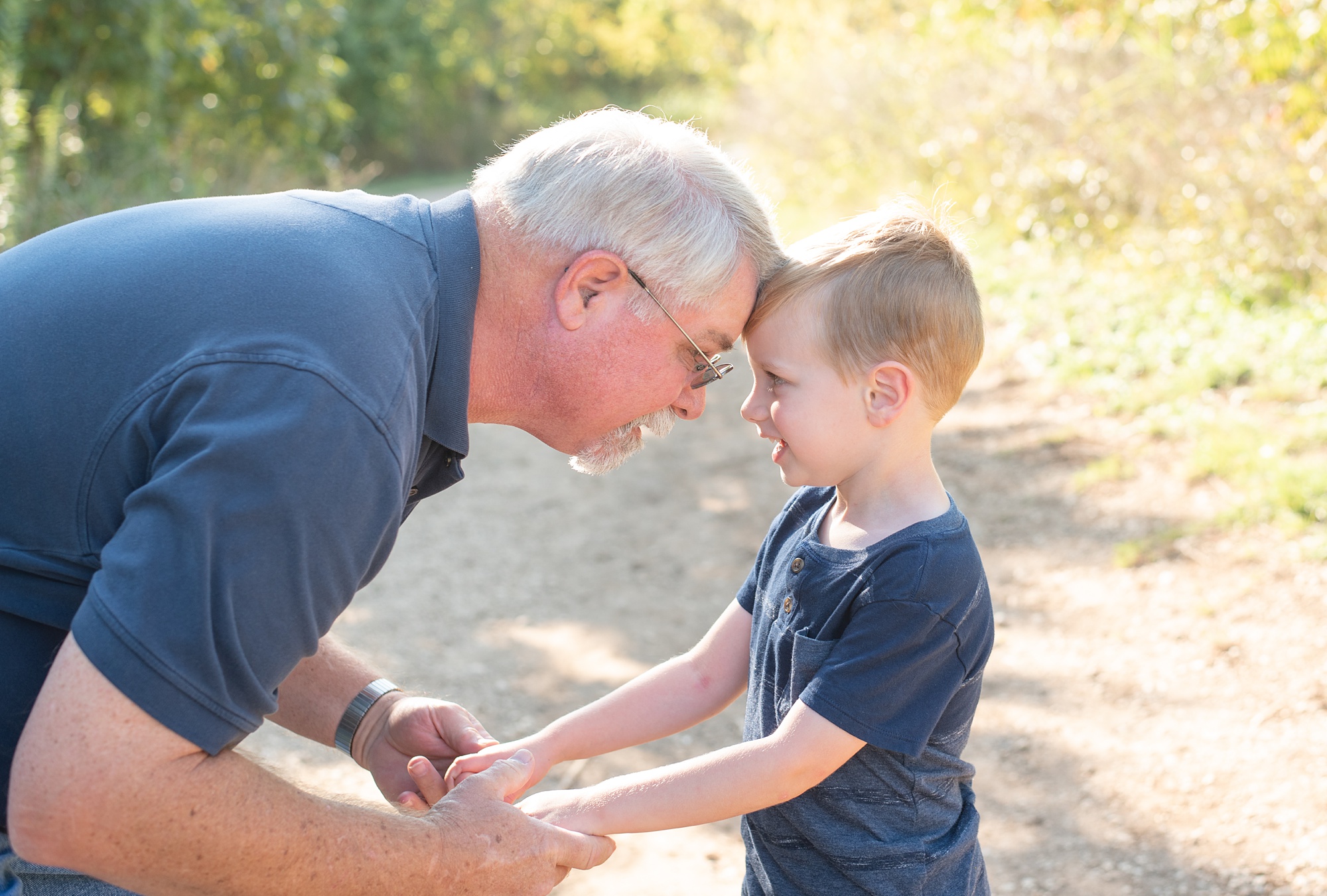 grandfather and son pose in field at Frisco Commons Park