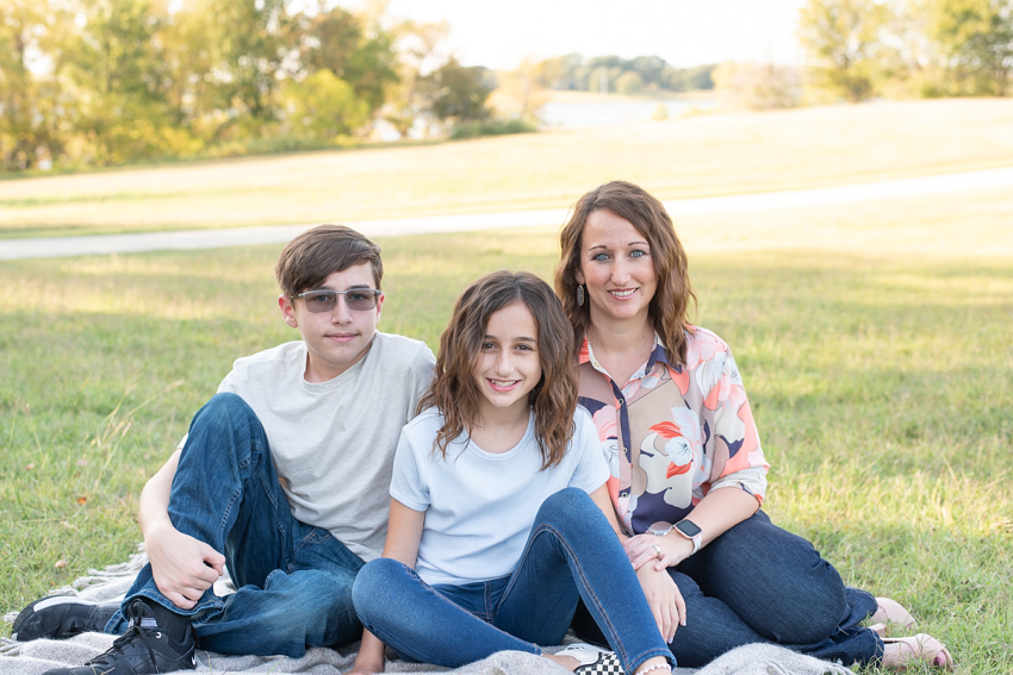 mom sits with two children in Little Elm Park