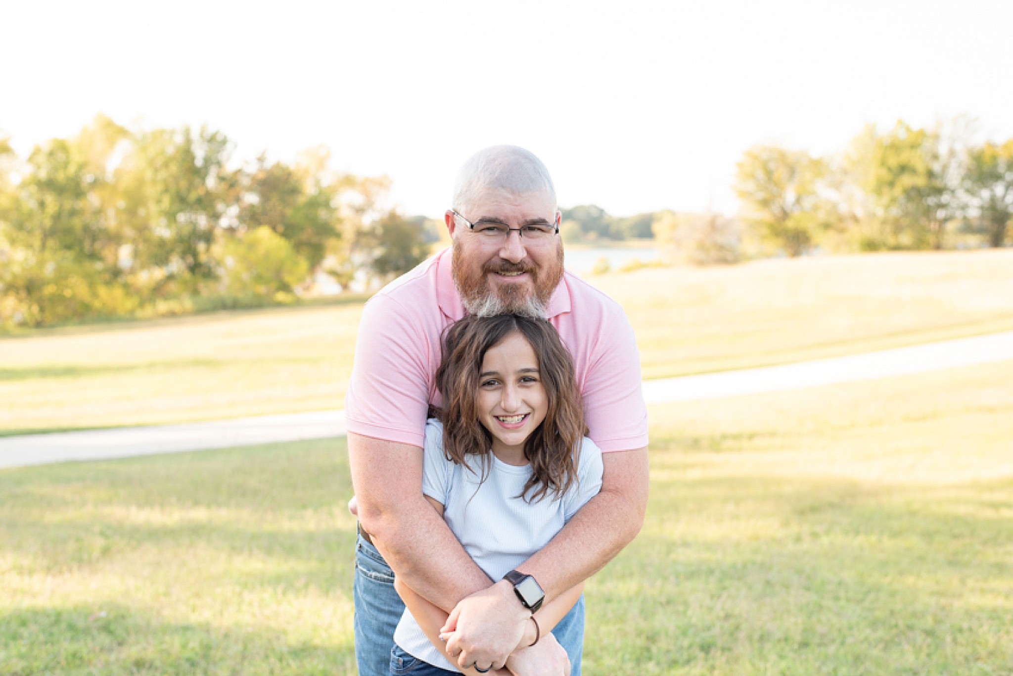 Little Elm Park family portraits with dad hugging daughter