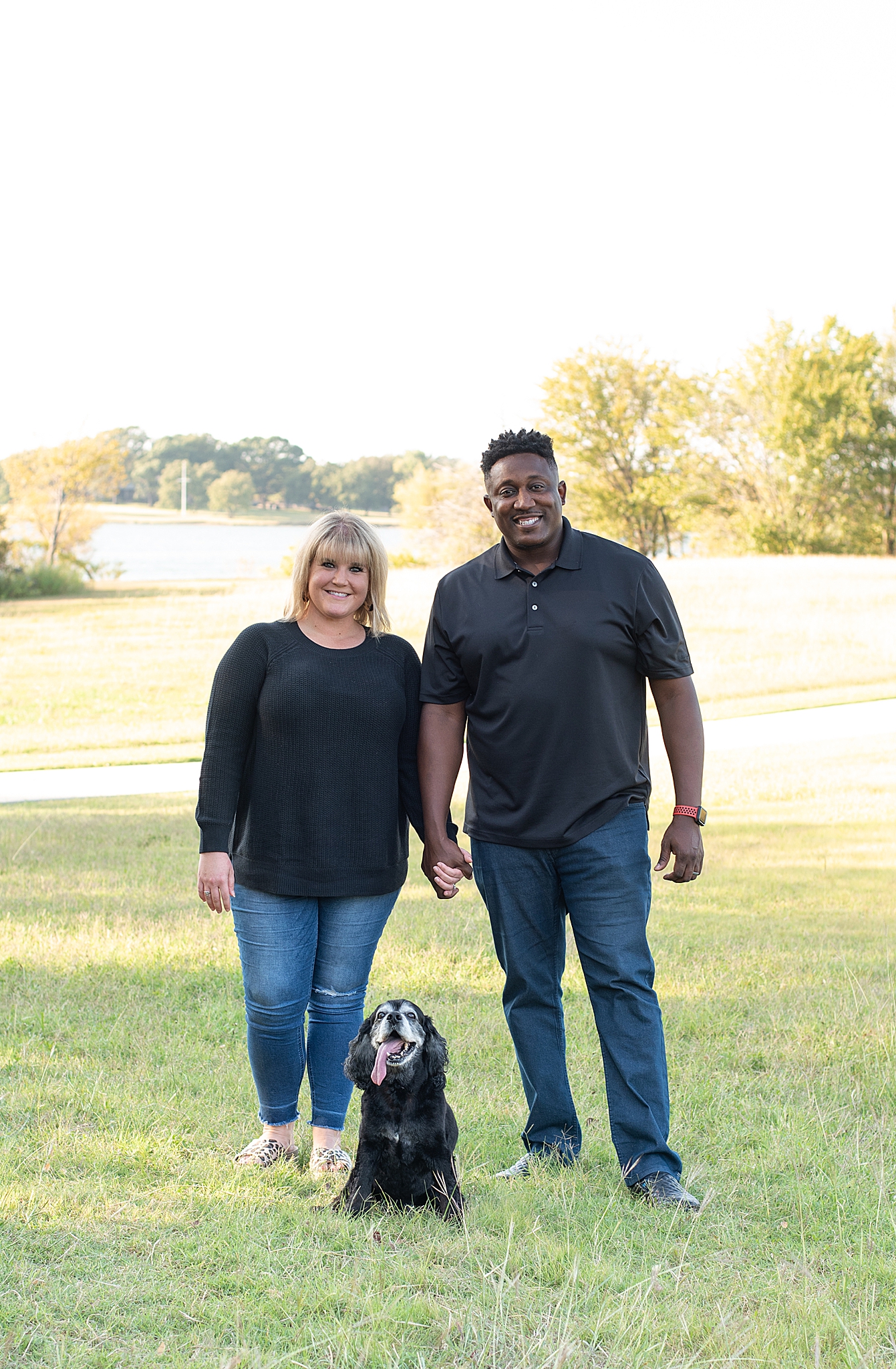 couple poses with dog in Little Elm Park