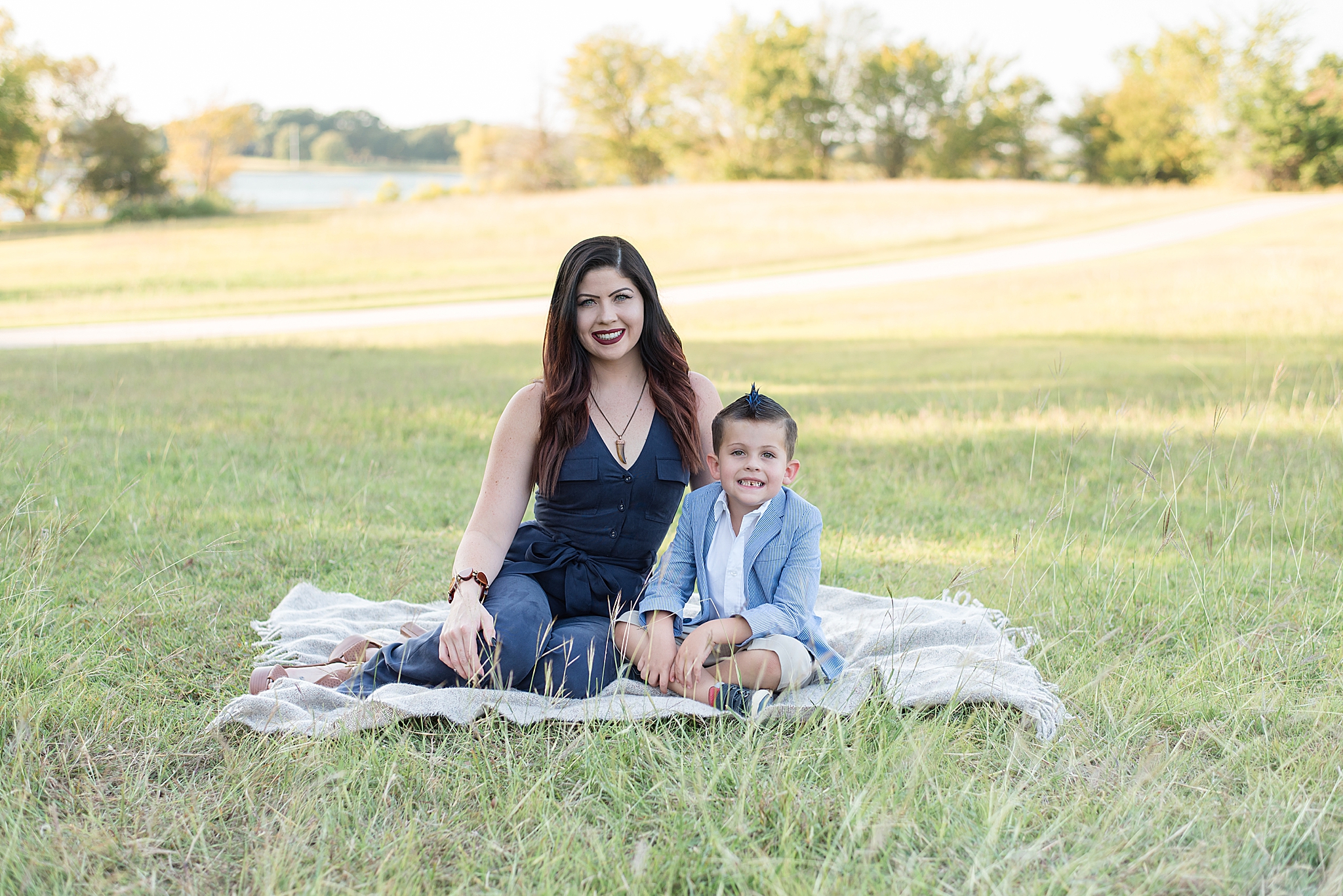 mom and son sit on blanket during Little Elm Park family portraits 