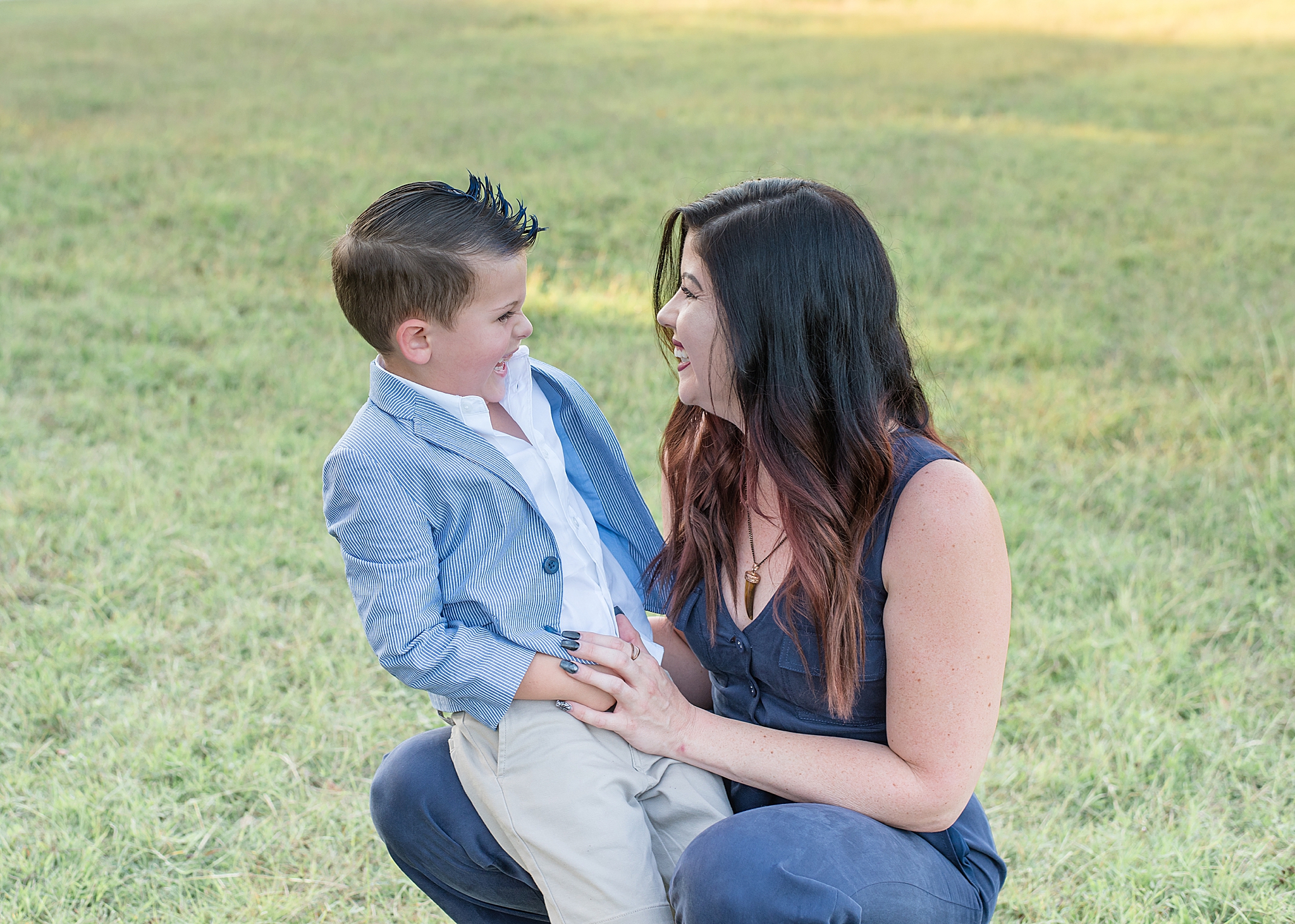 son laughs with mom during Little Elm Park family portraits