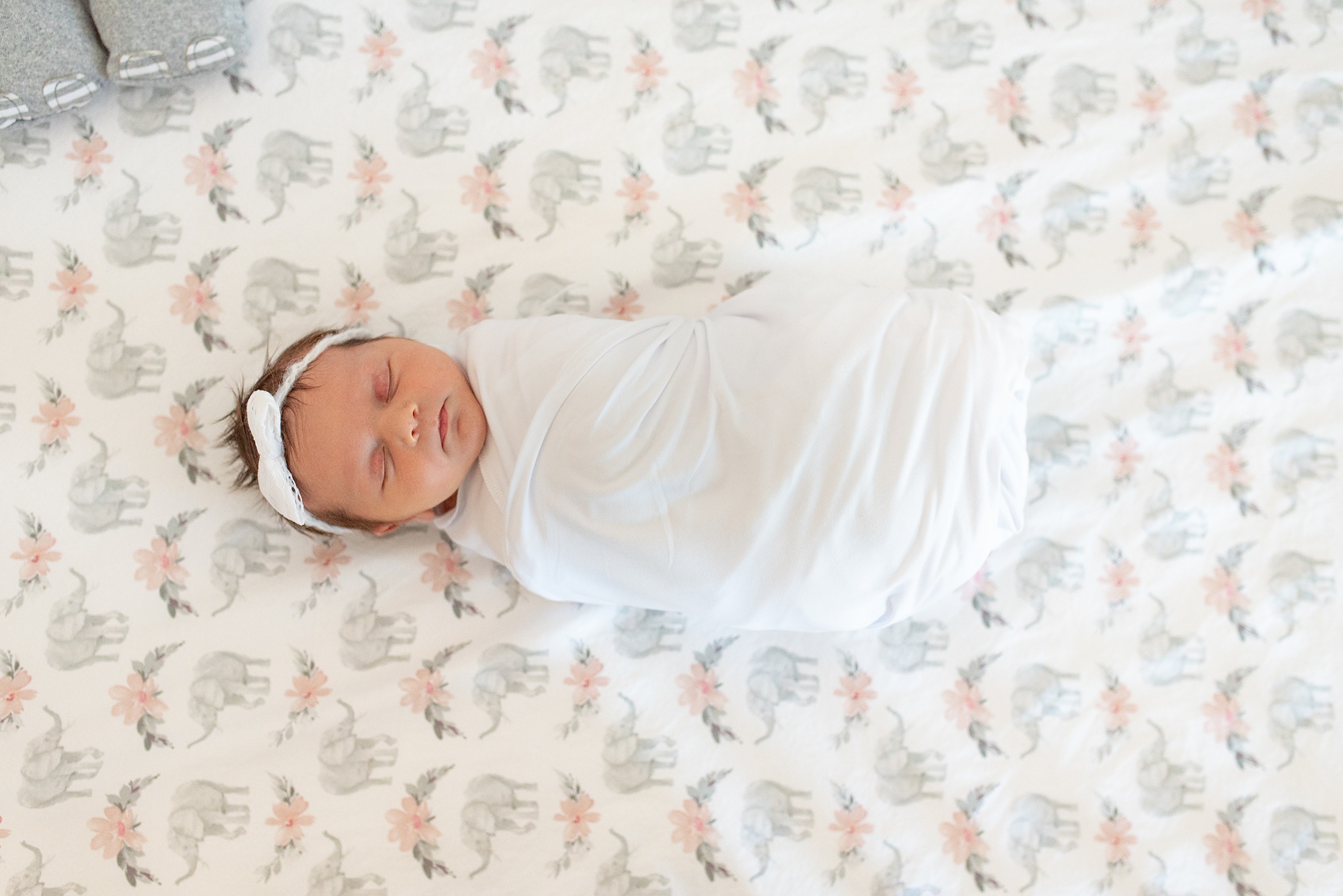 newborn baby girl sleeps on sheets in crib during Aubrey TX lifestyle newborn session 