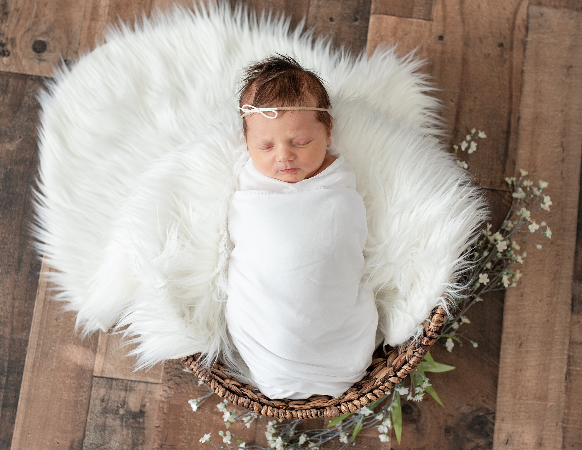 baby girl in blanket with white floki sleeps during Aubrey TX lifestyle newborn session 