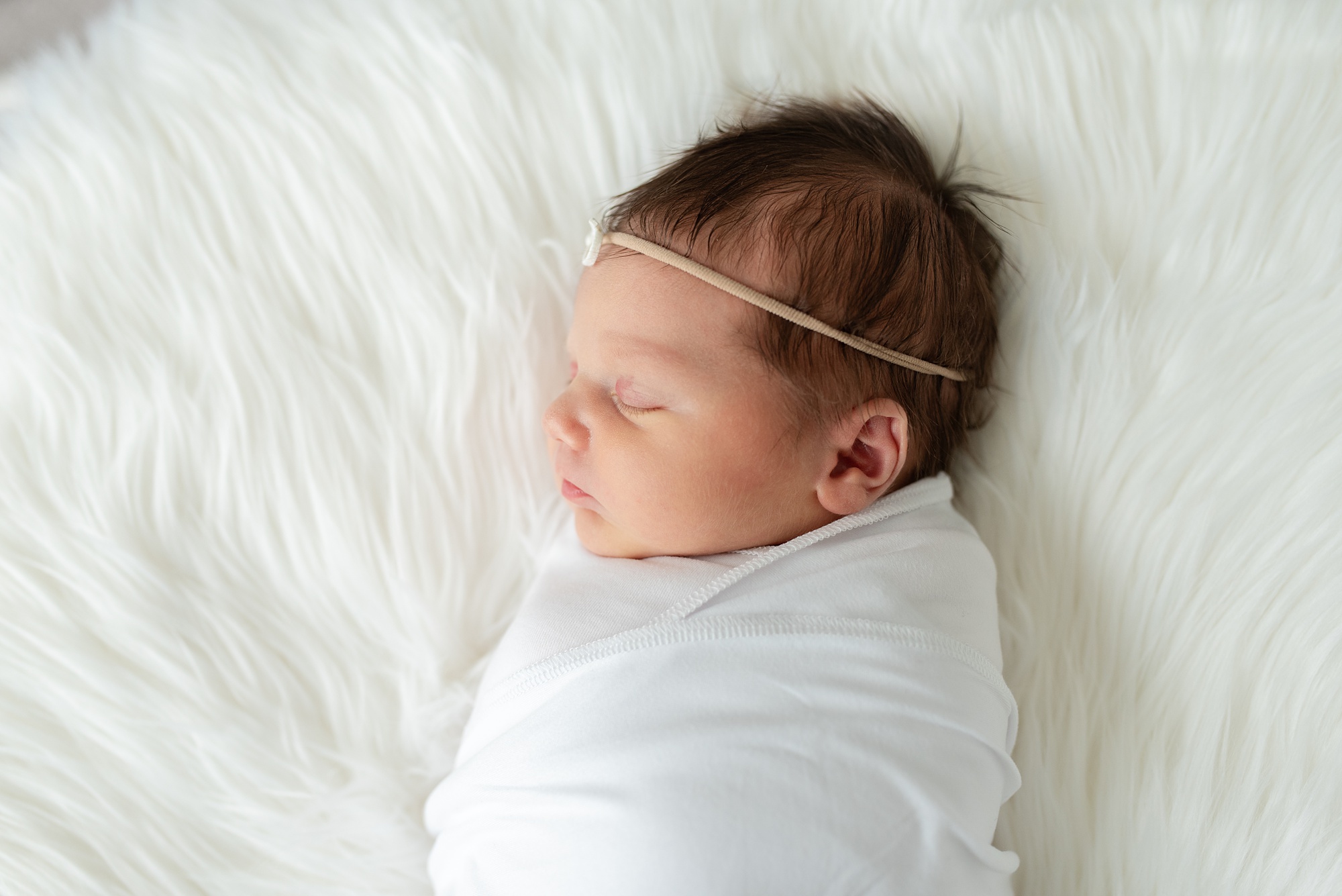 baby sleeps on white floki during Aubrey TX lifestyle newborn session 