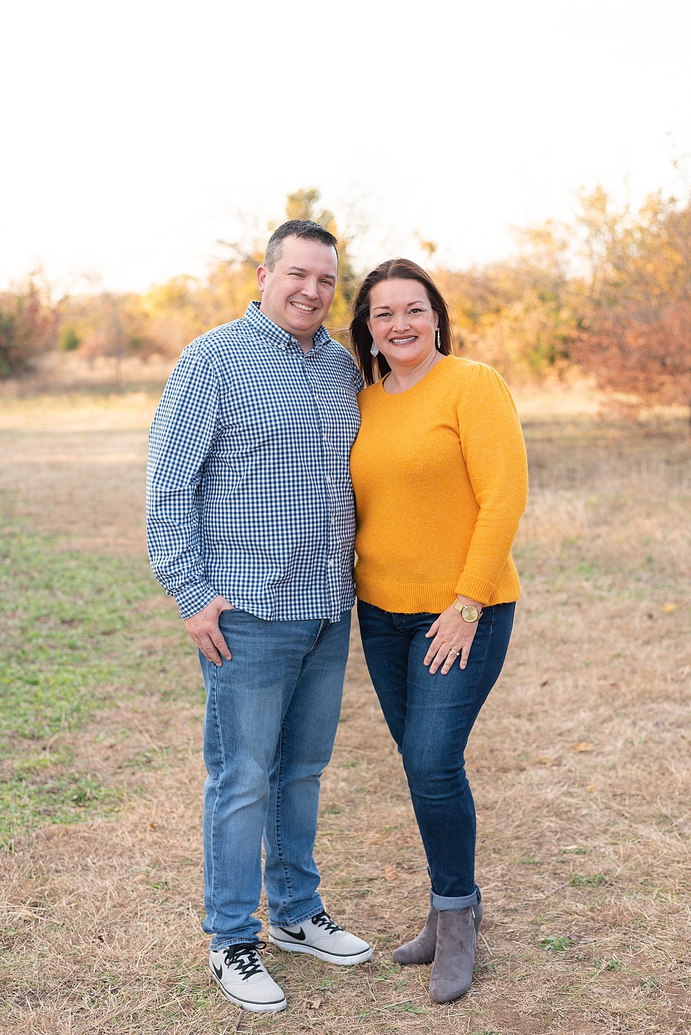 parents hug during fall family photos in Texas