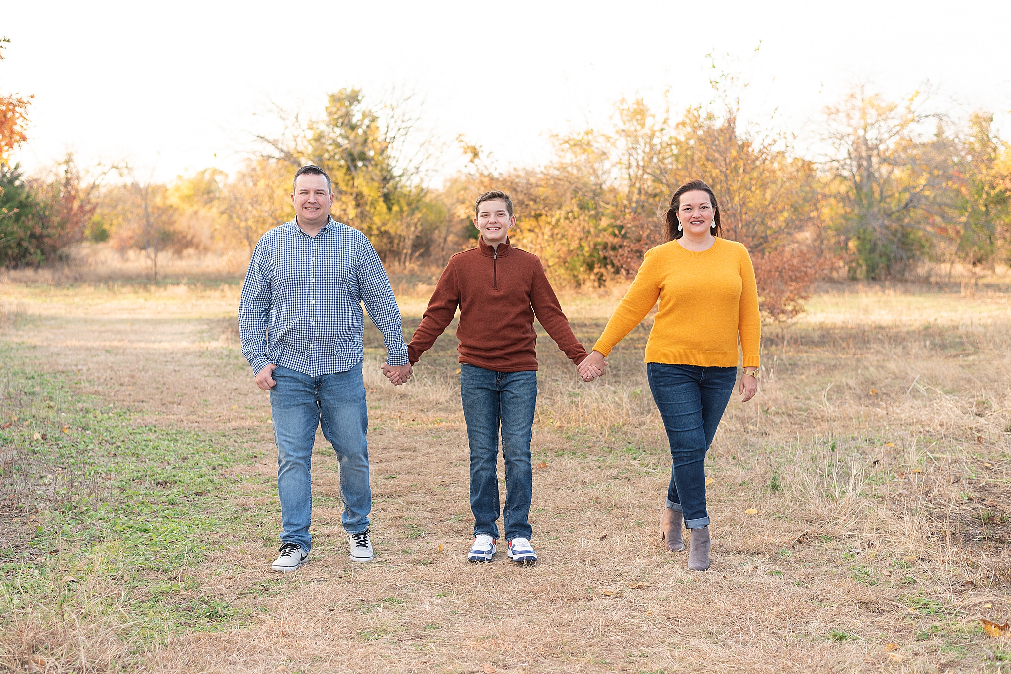 parents and teenage son pose together during Frisco Field Mini Sessions