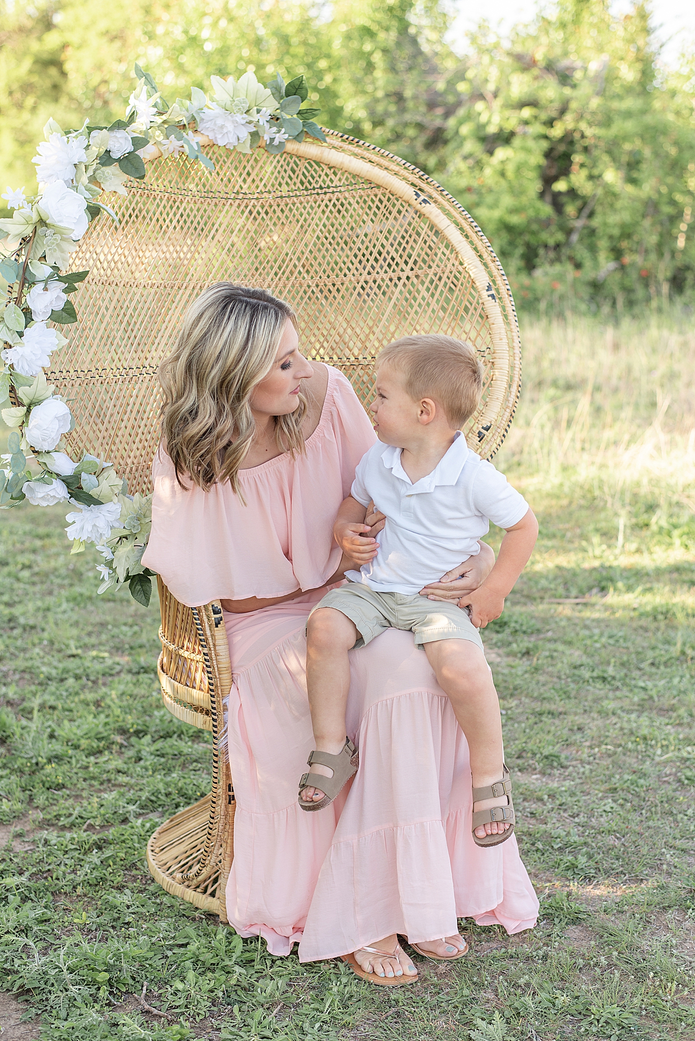 mom sits with toddler on lap during Frisco Field Family + Mommy and Me Session