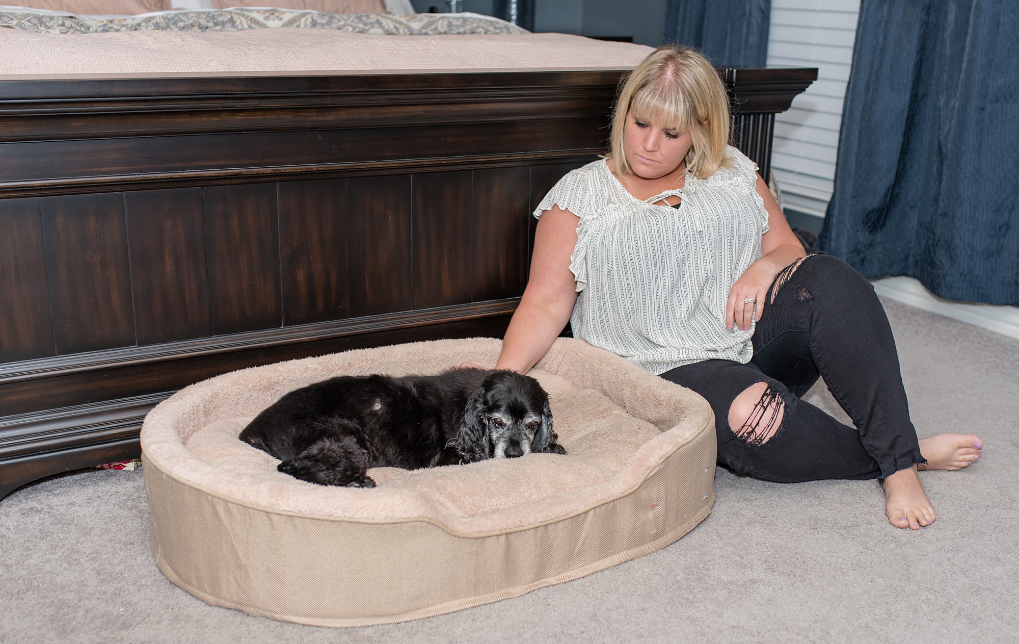 woman looks at dog during family photos at home