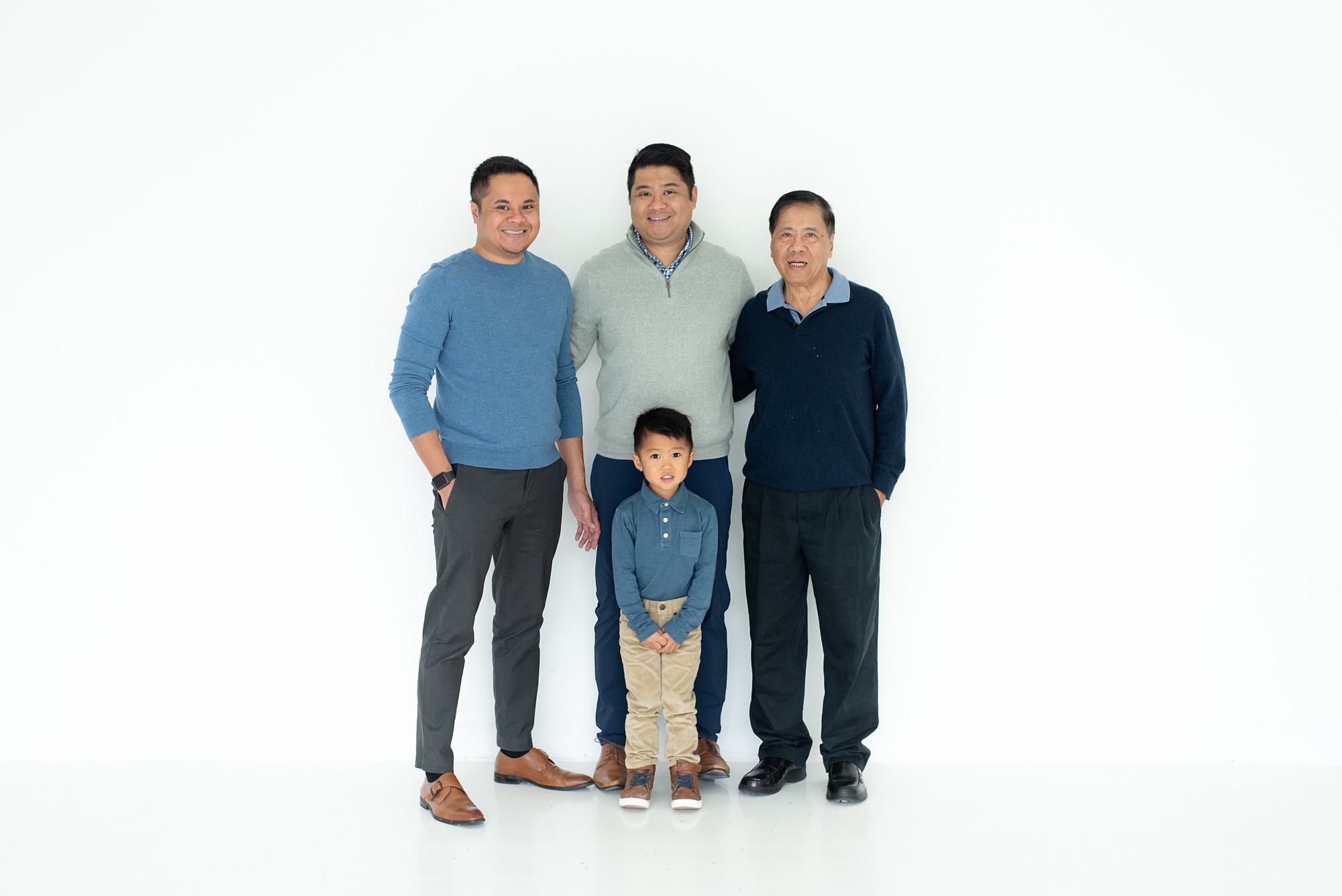 dad poses with sons and grandson during Lumen Room family portraits