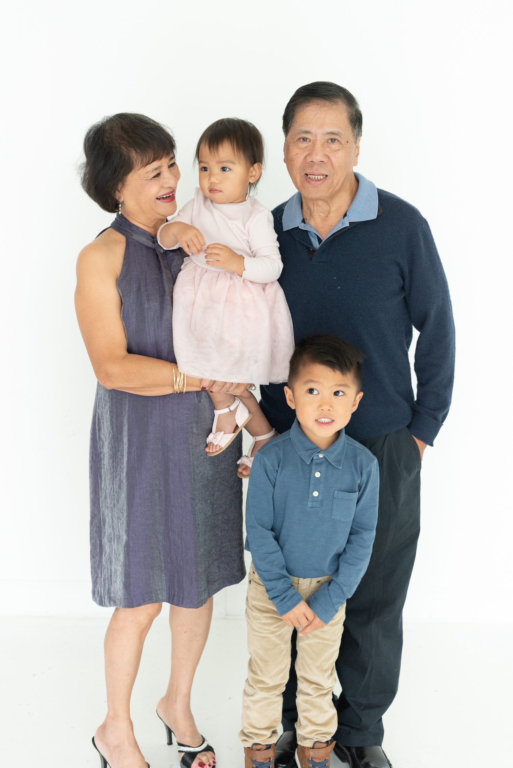 grandparents pose with young grandchildren during TX family photos
