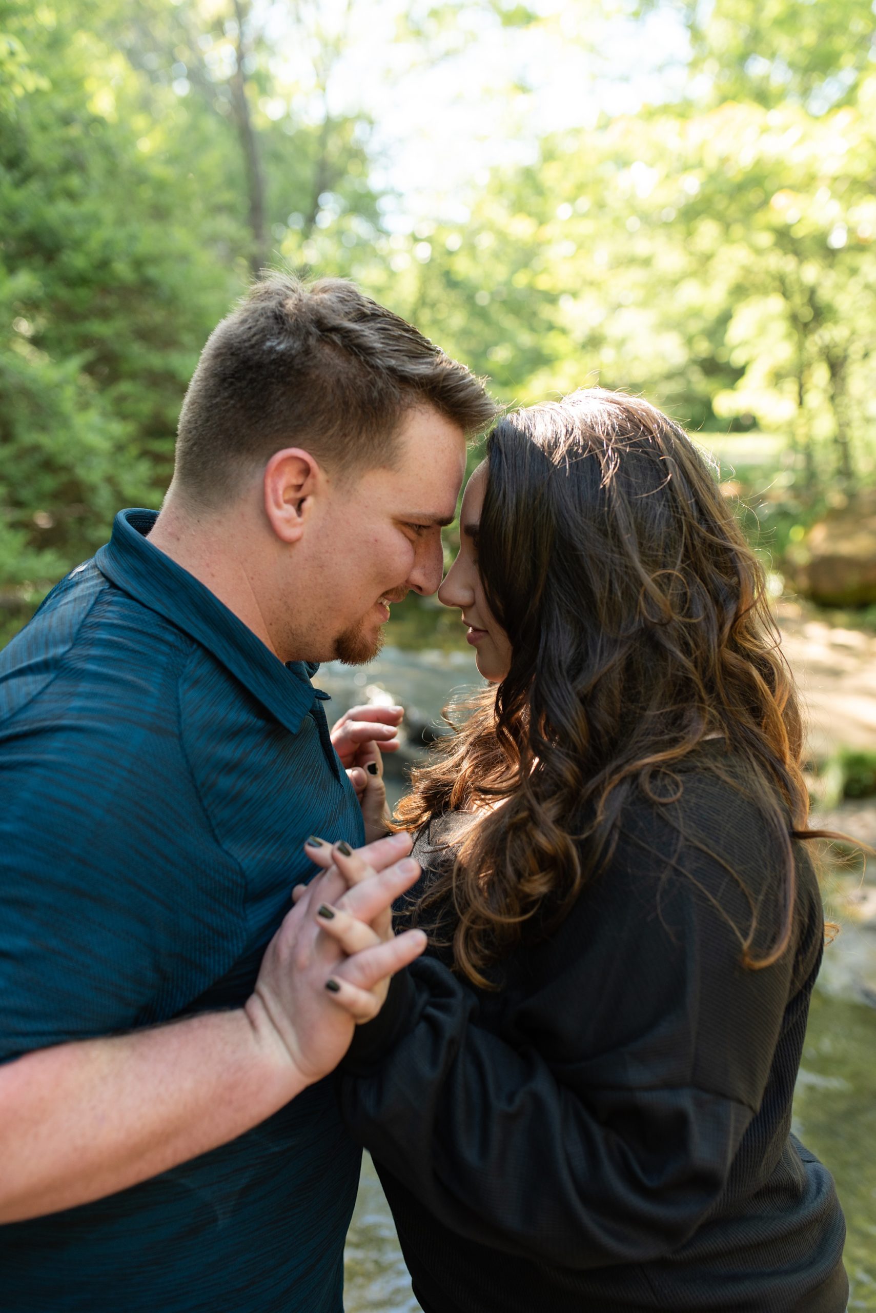 Texas couple stands touching foreheads during engagement photos