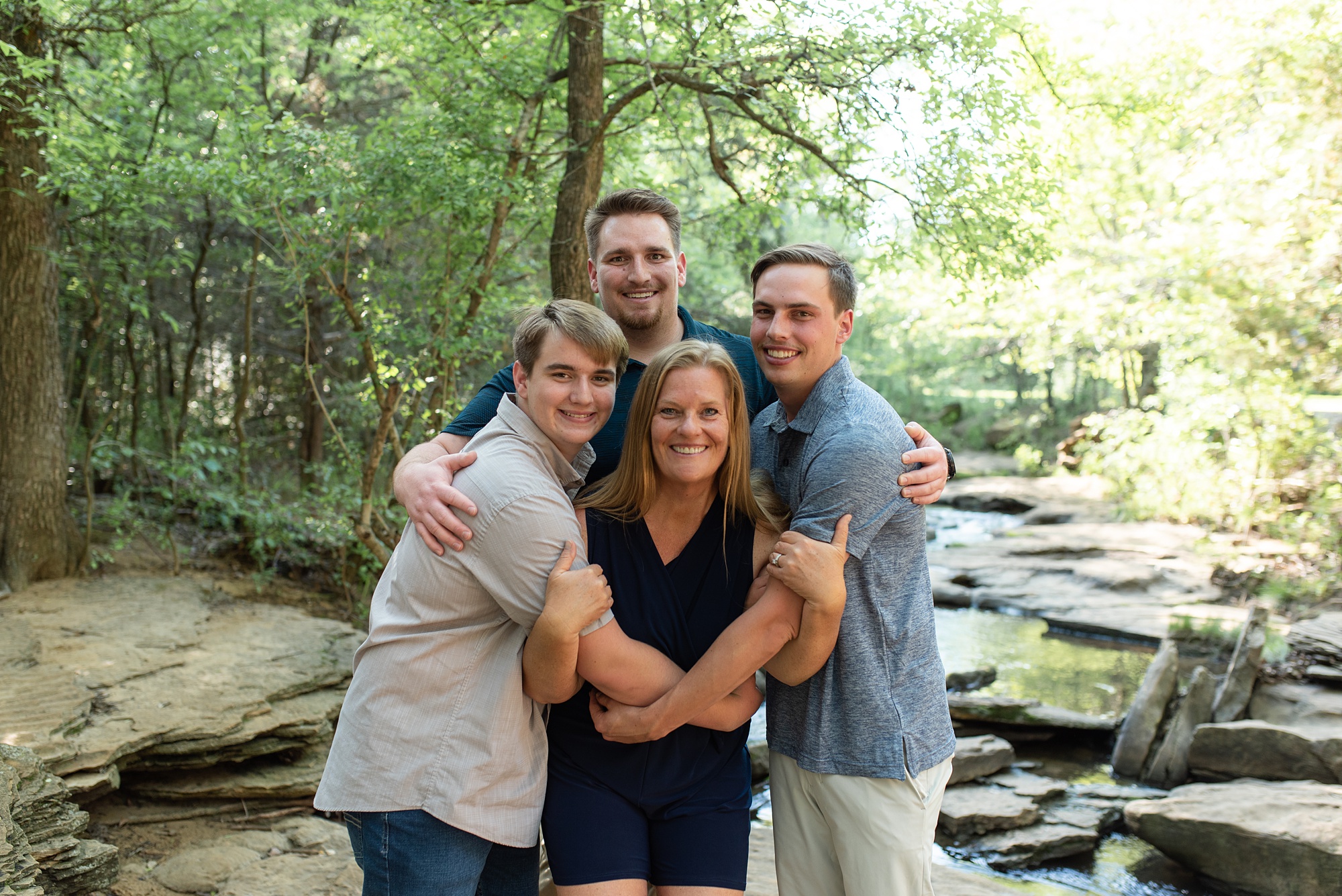 three sons hug mom during Texas family photos 