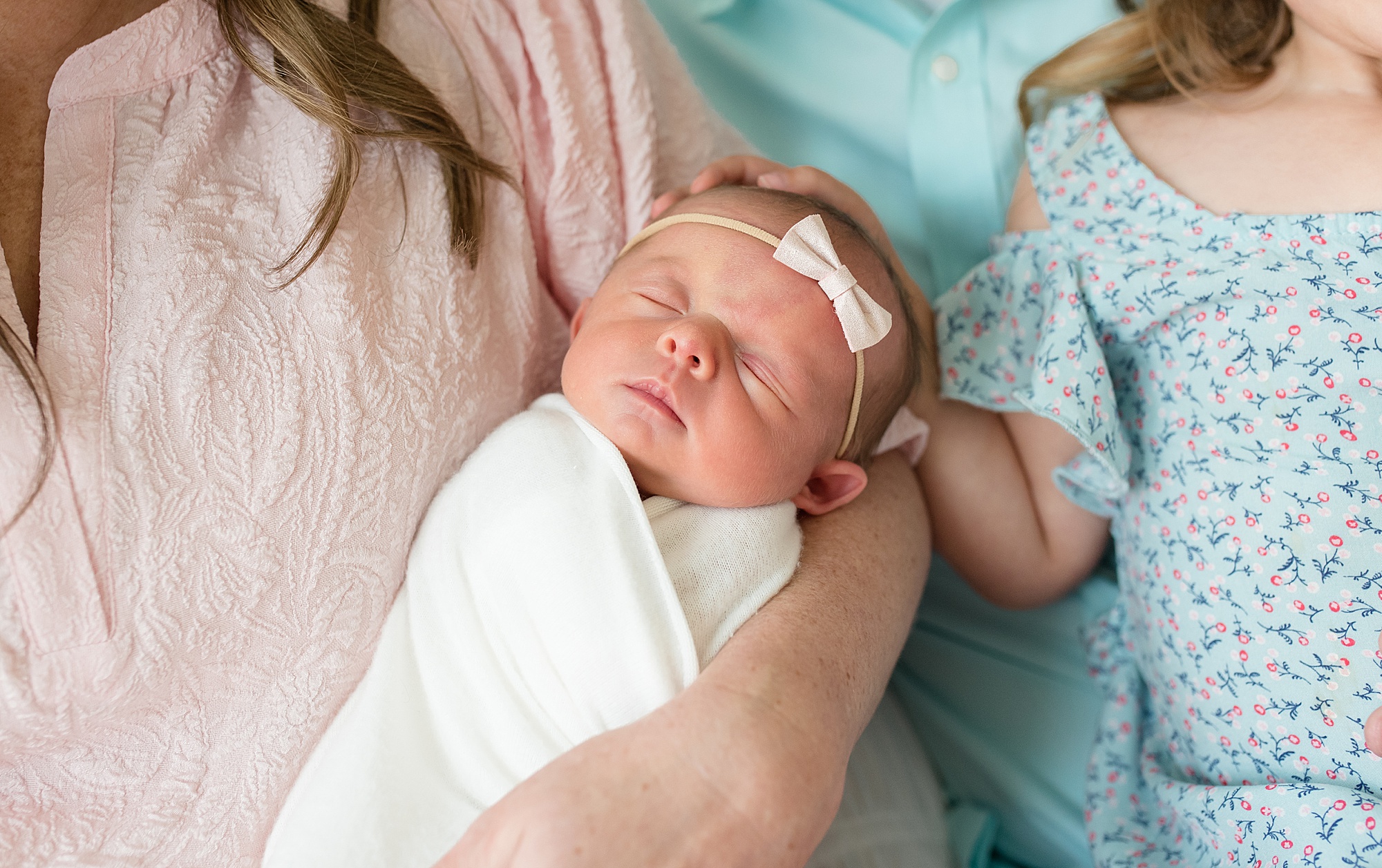 mom holds newborn baby girl during lifestyle newborn session 