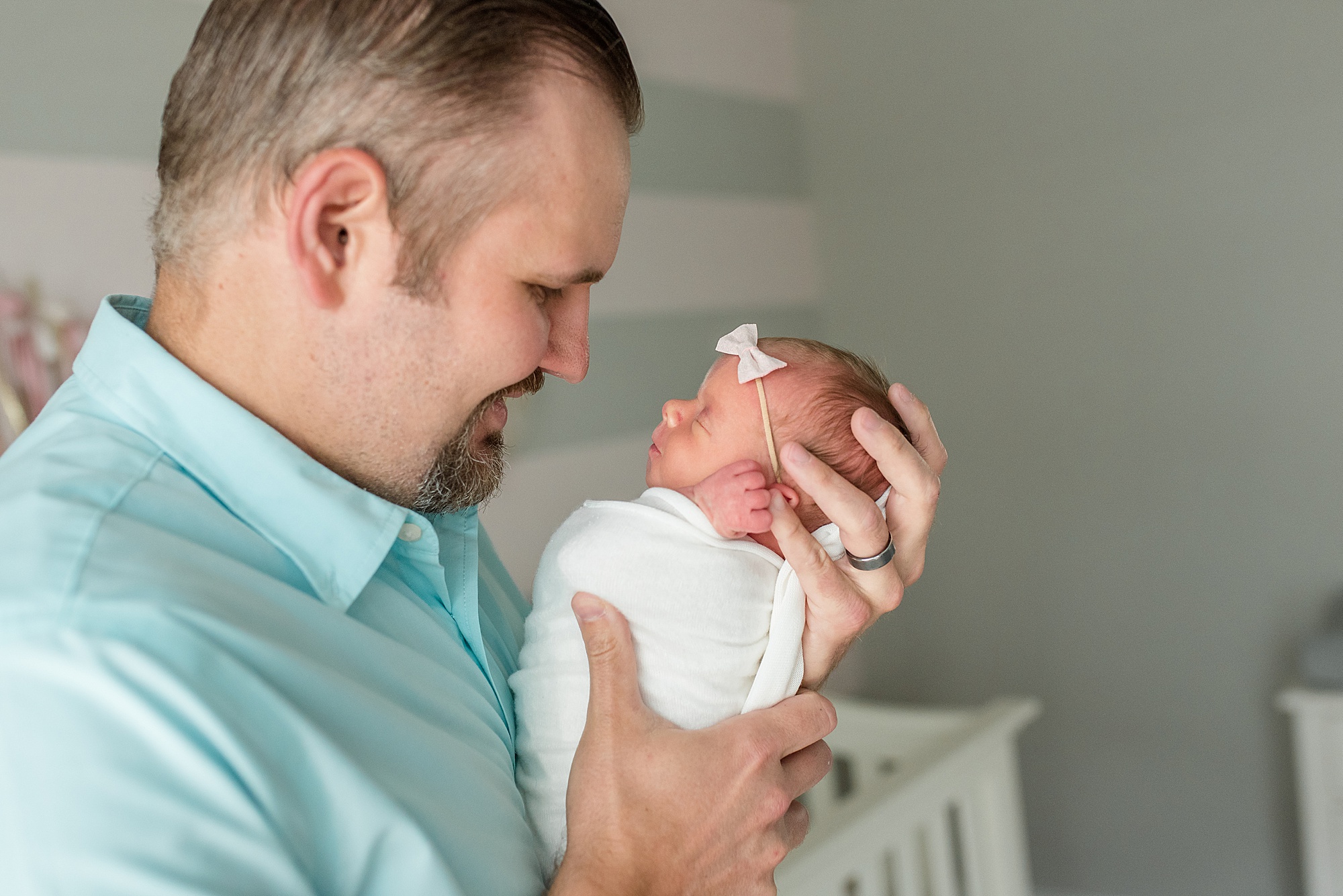 dad holds baby girl during newborn session