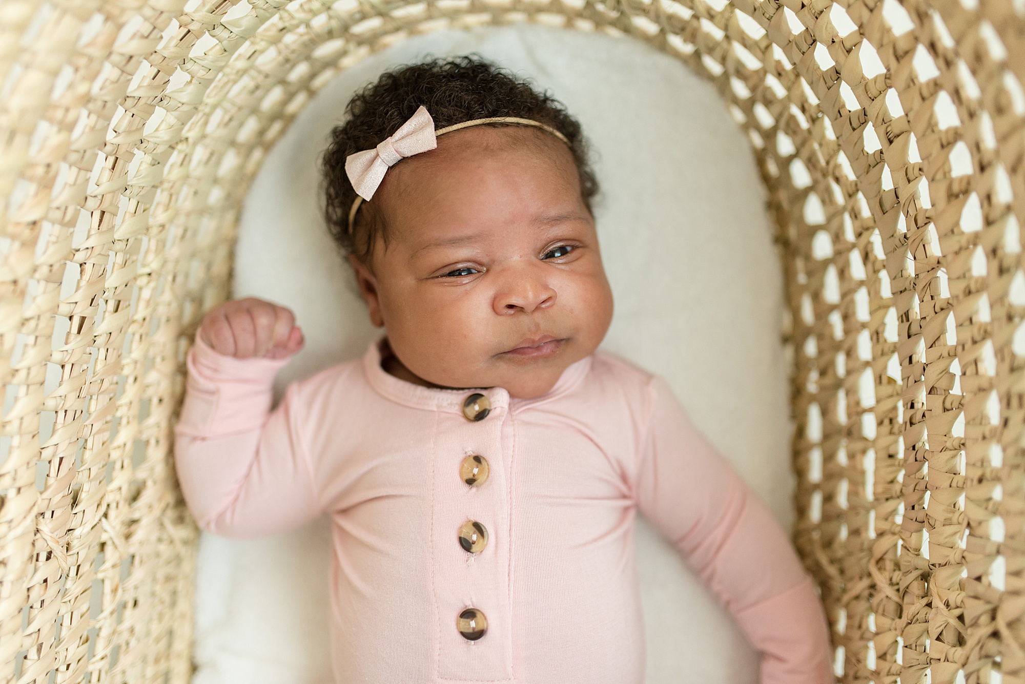 Newborn baby girl in pink during TX newborn session