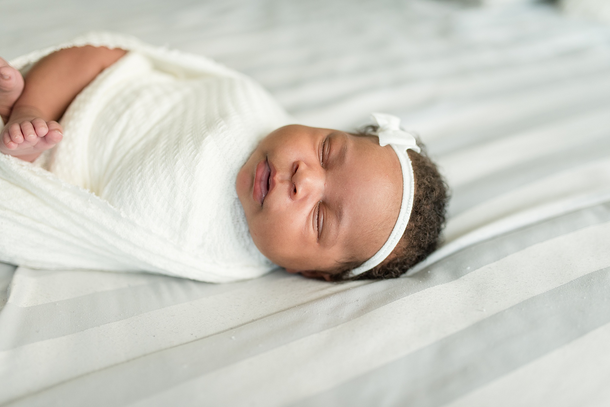 newborn baby girl sleeps during newborn portraits in Denton TX