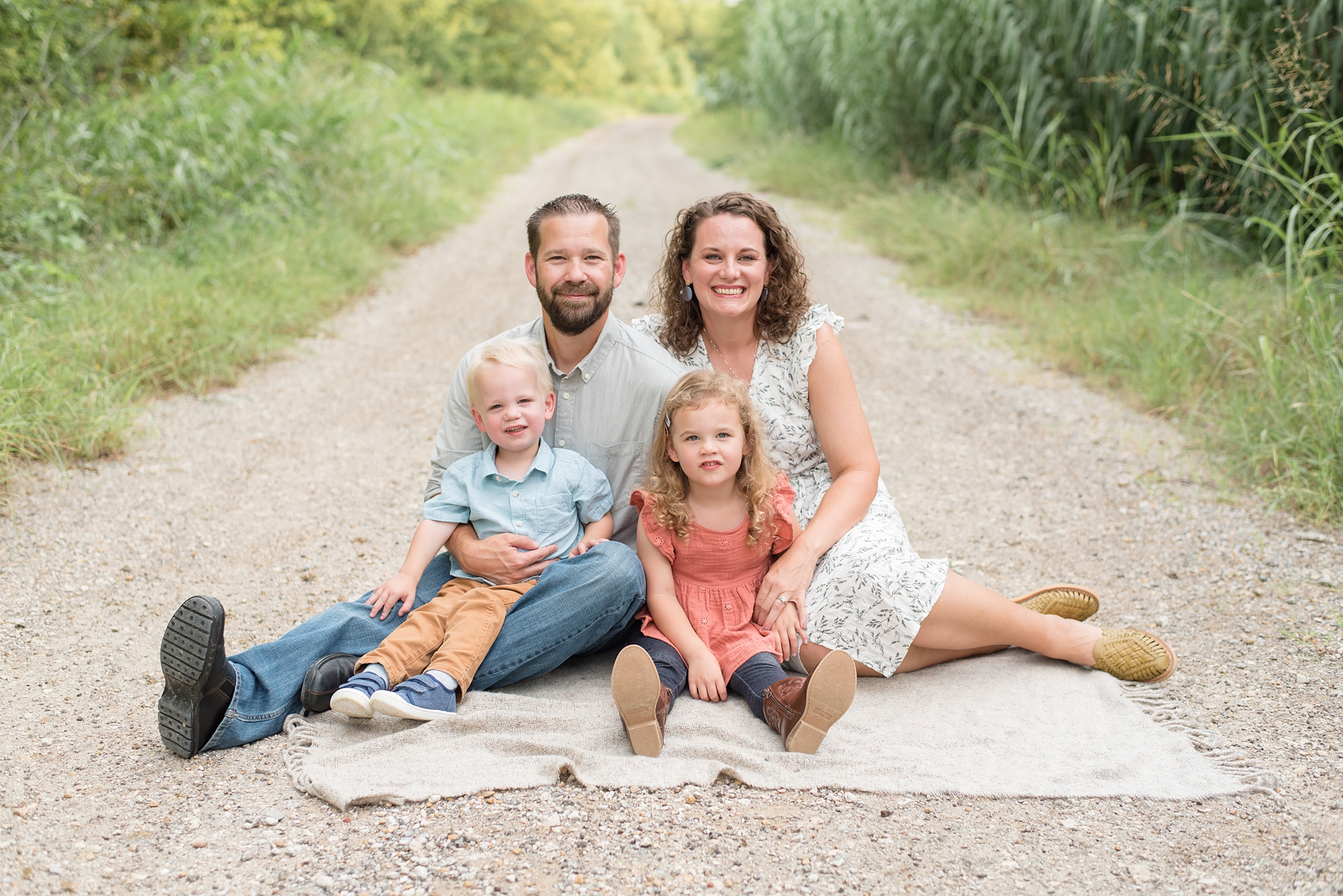 family of four sits together for Little Elm Family Session