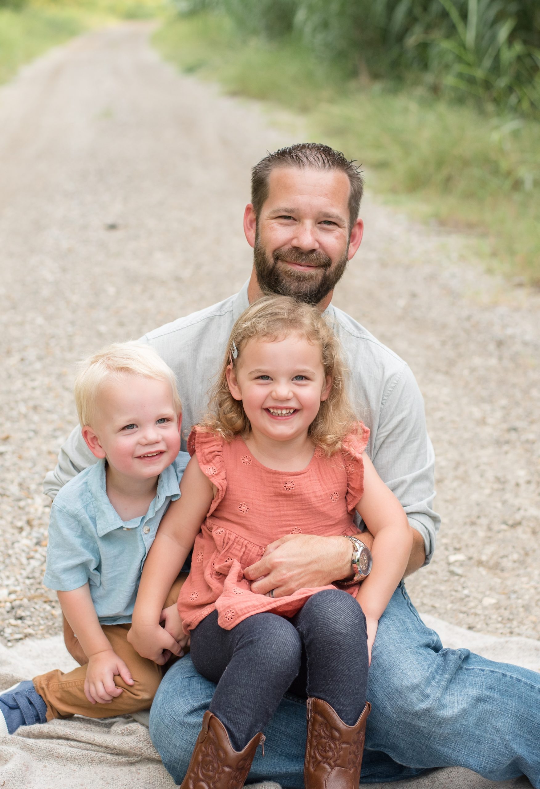 dad sits with his son + daughter during family portraits