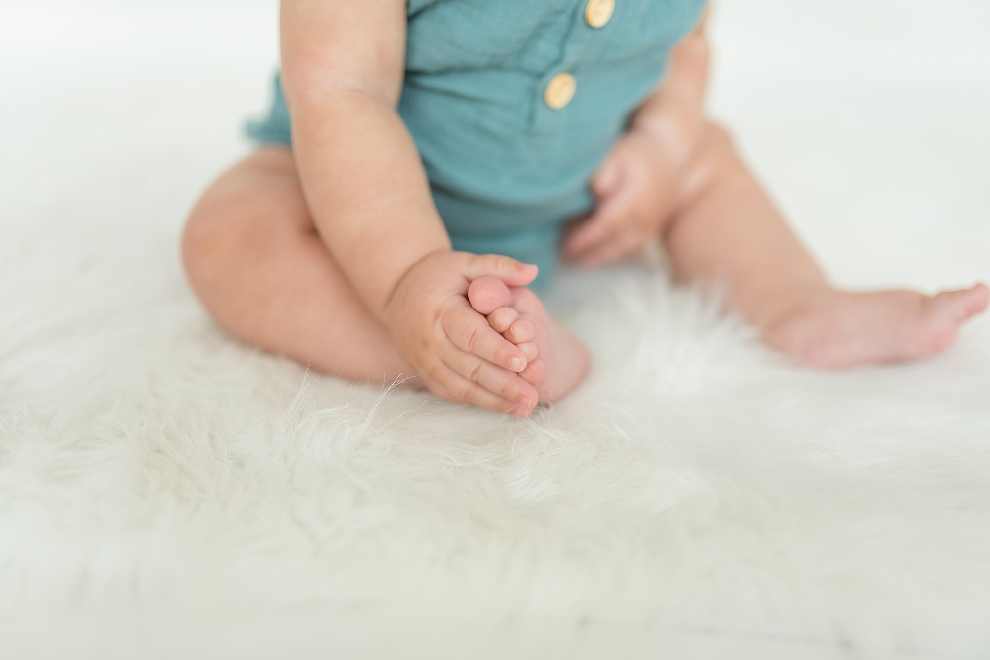6 month infant playing with toes