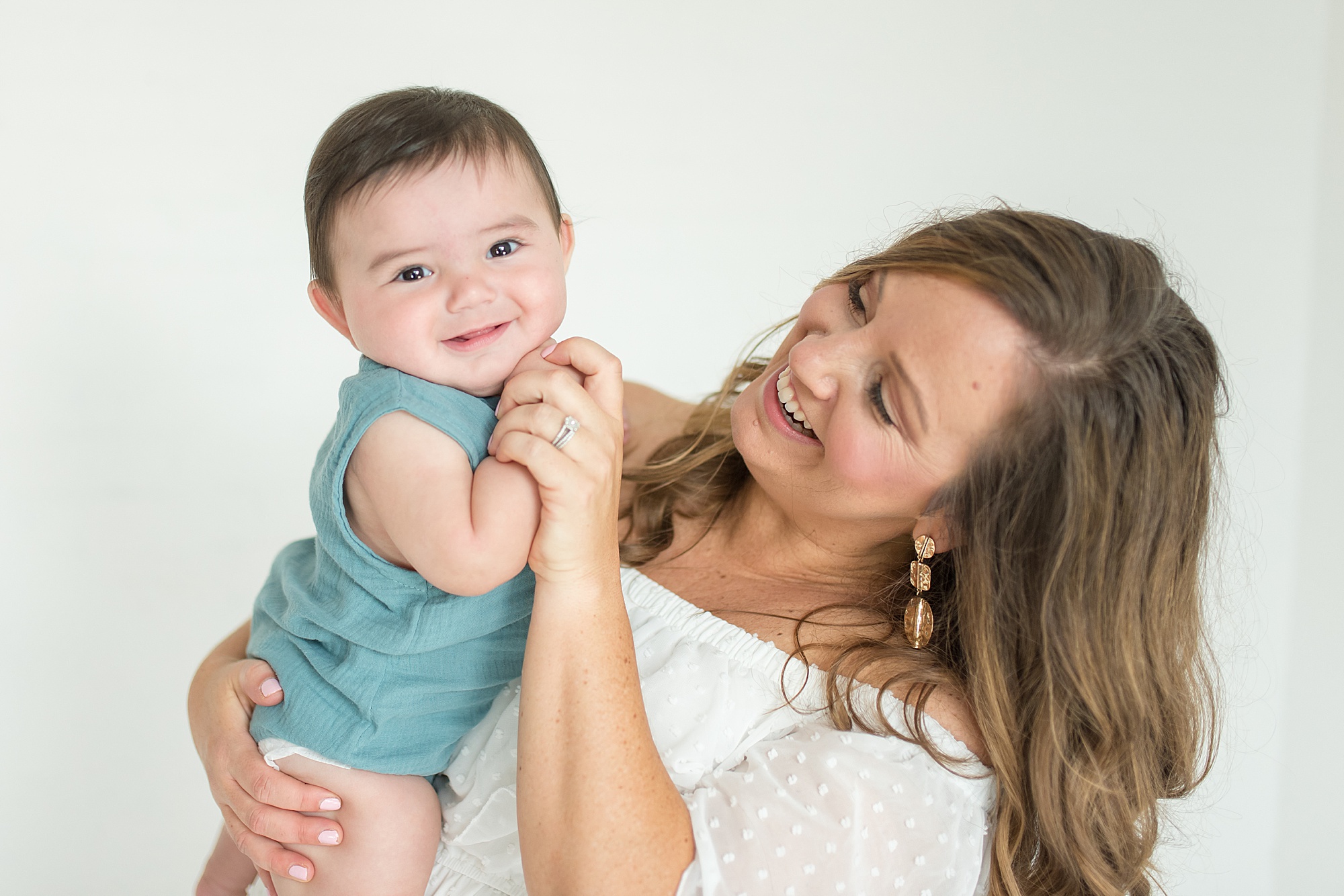 mom holds baby boy during milestone photos by TX newborn photography Lindsey Dutton