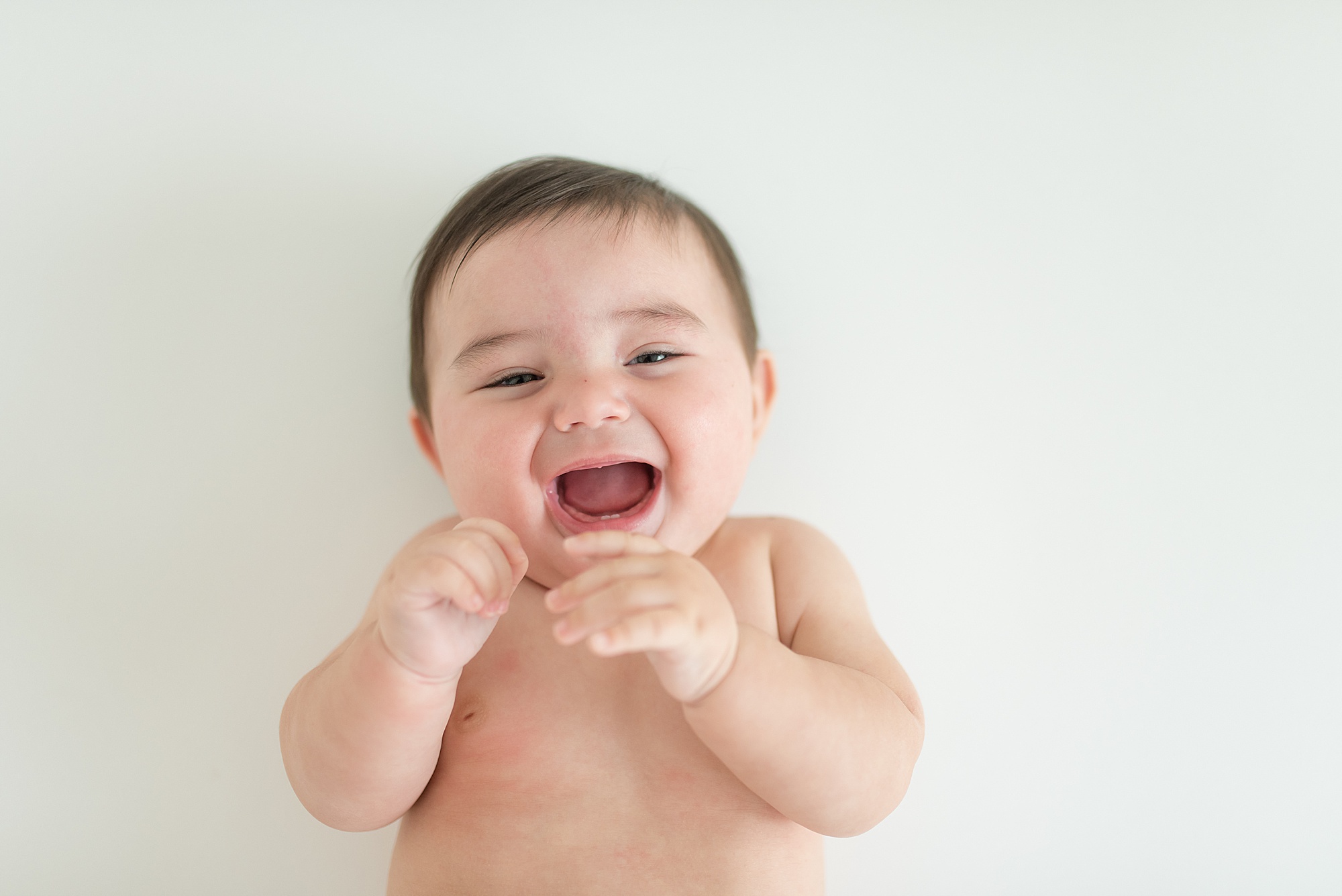 6 Month old baby giggles during newborn Milestone Session by Lindsey Dutton Photography