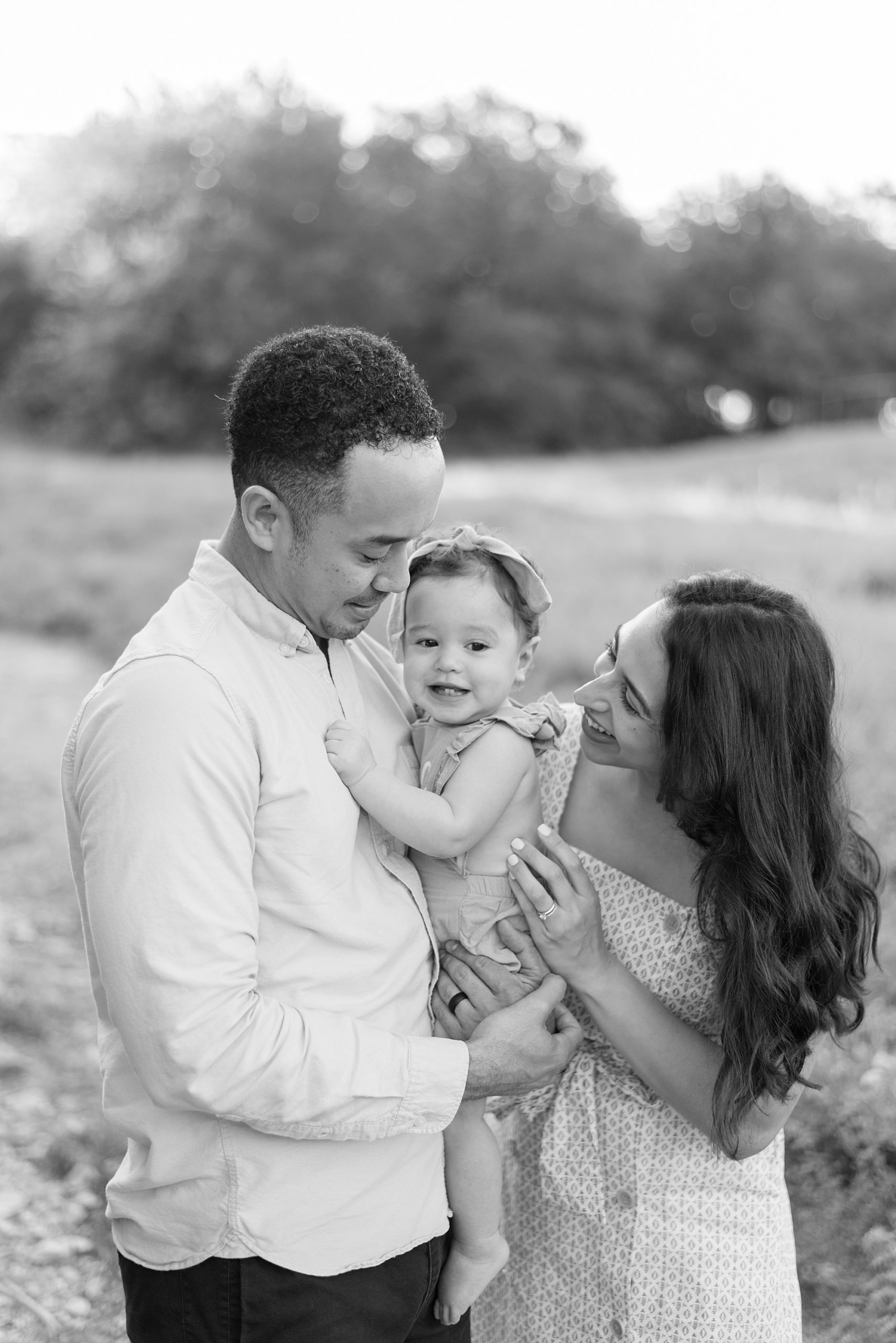parents hold their one year old during family session