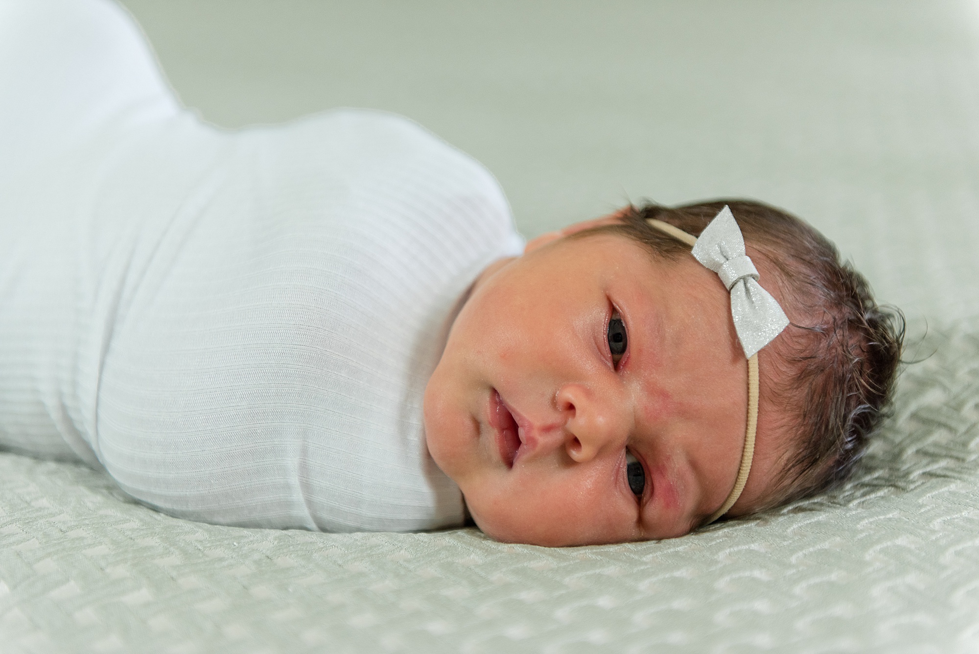 newborn baby girl swaddled in white during Carrollton Texas newborn session