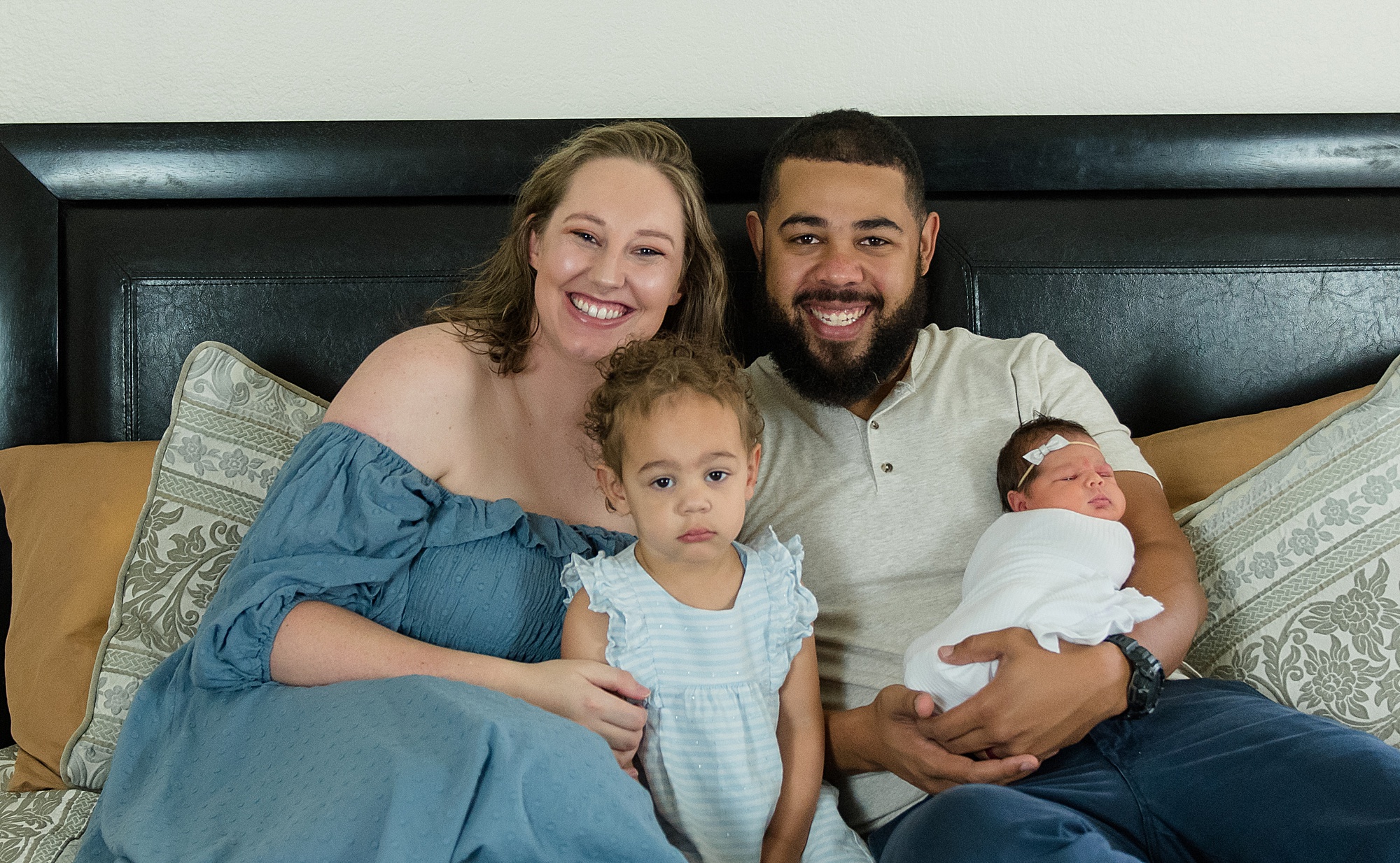 new family of four during in-home lifestyle newborn session