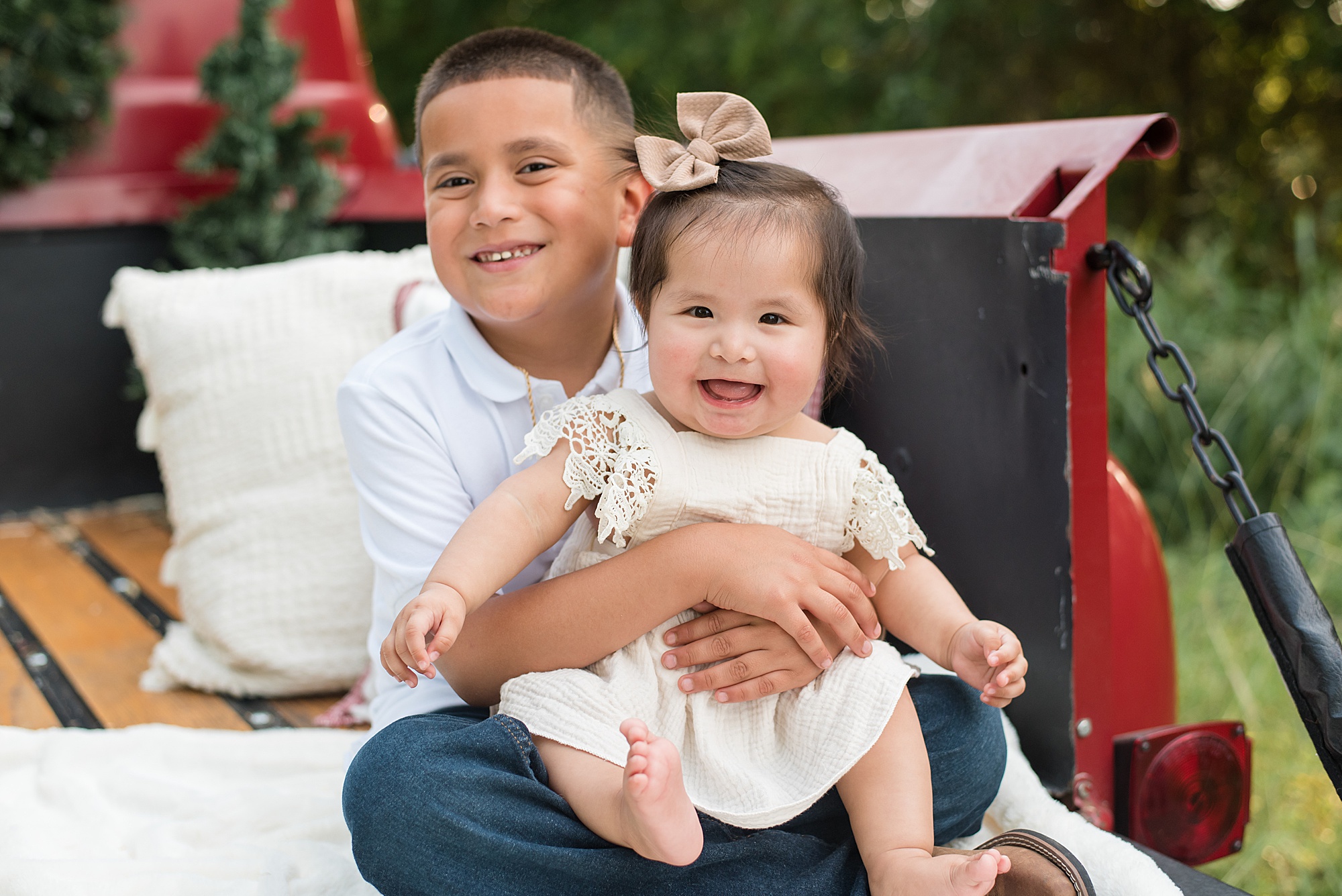 big brother holds little sister during little Elm family portraits