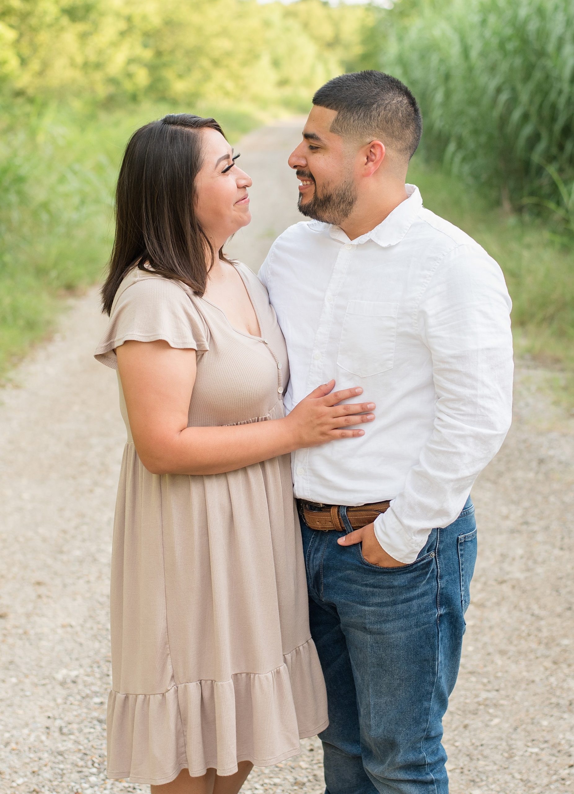 husband and wife look at each other during family photos