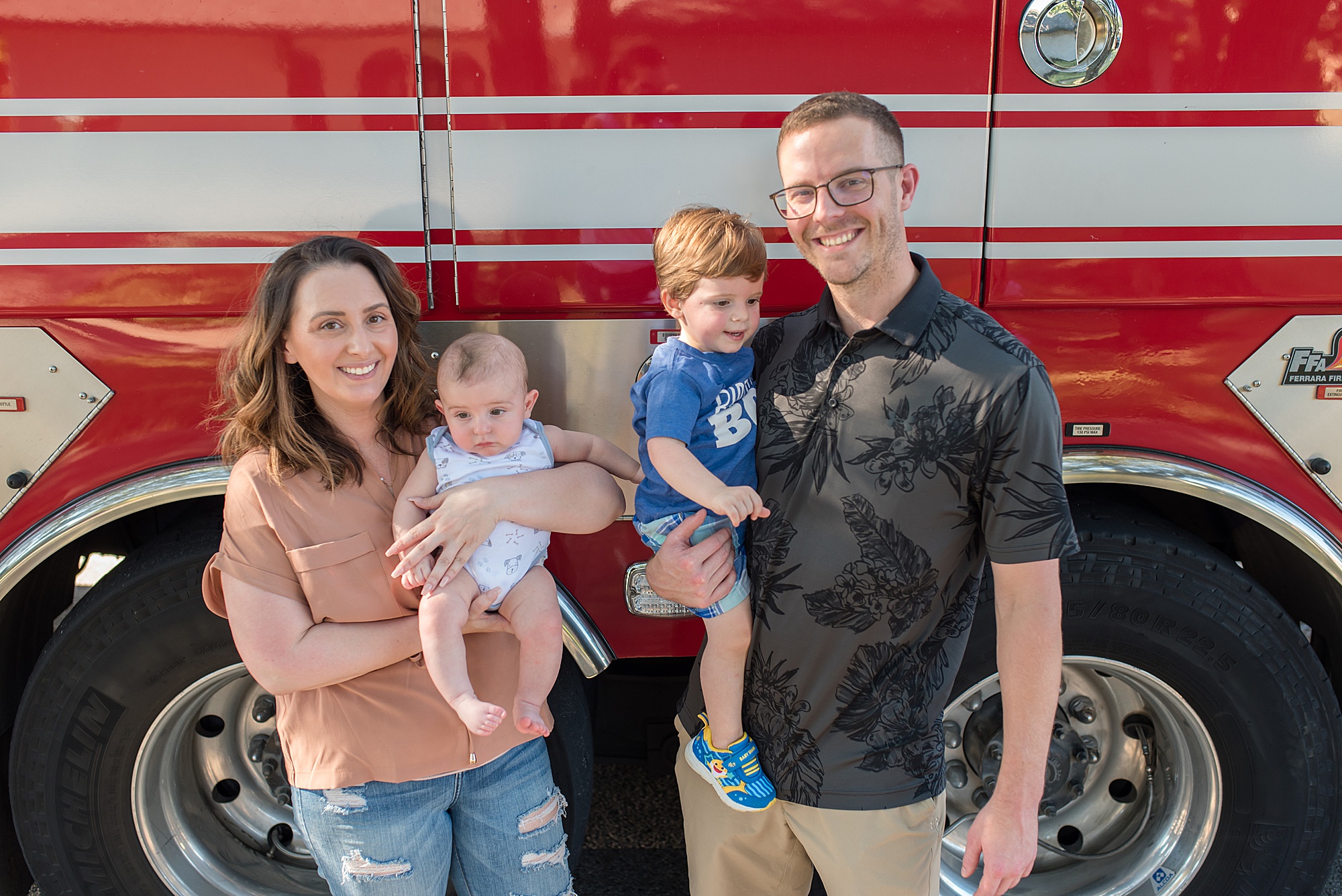 family portraits in front of fire truck