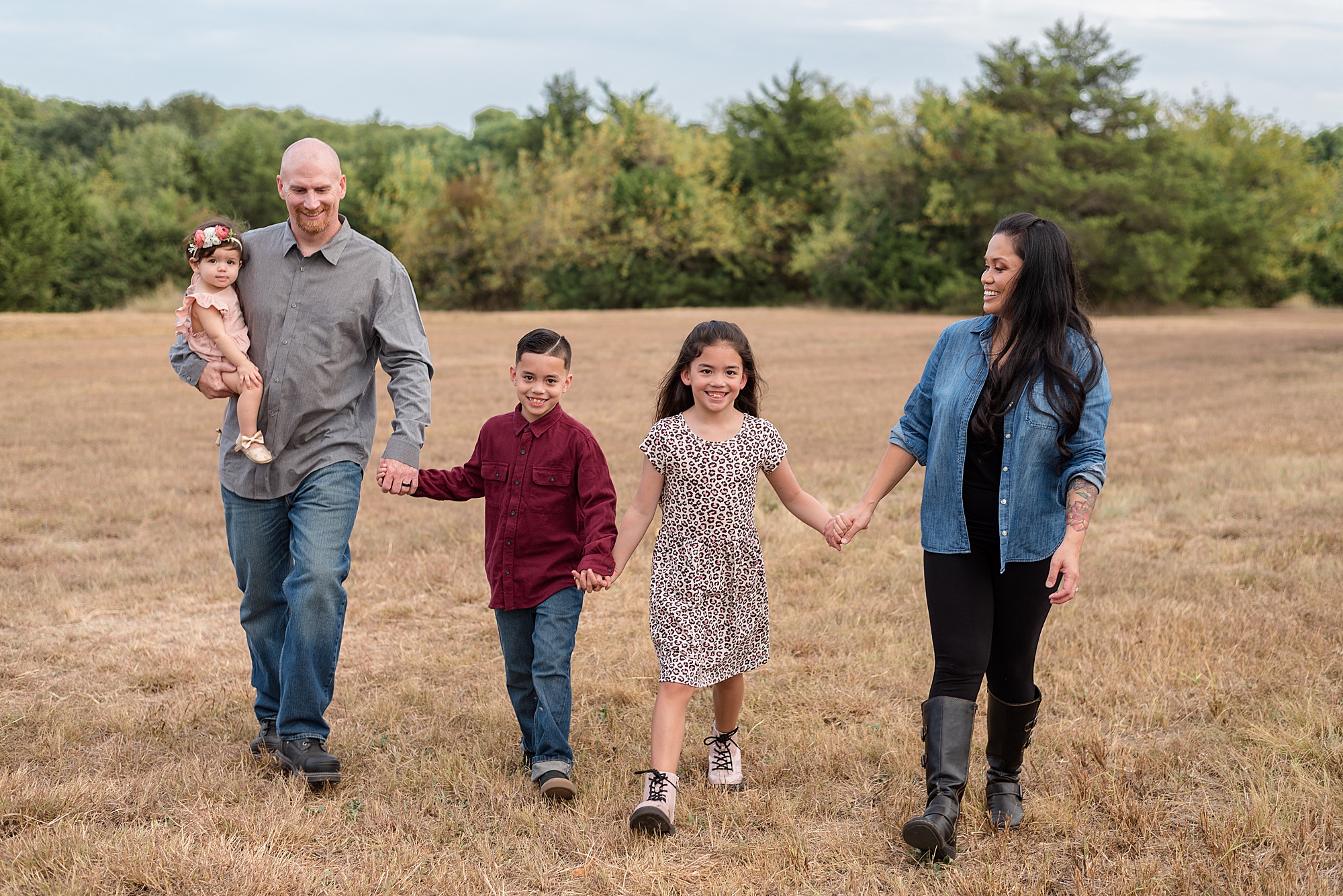 family walks together holding hands in Erwin Park during Family Photos
