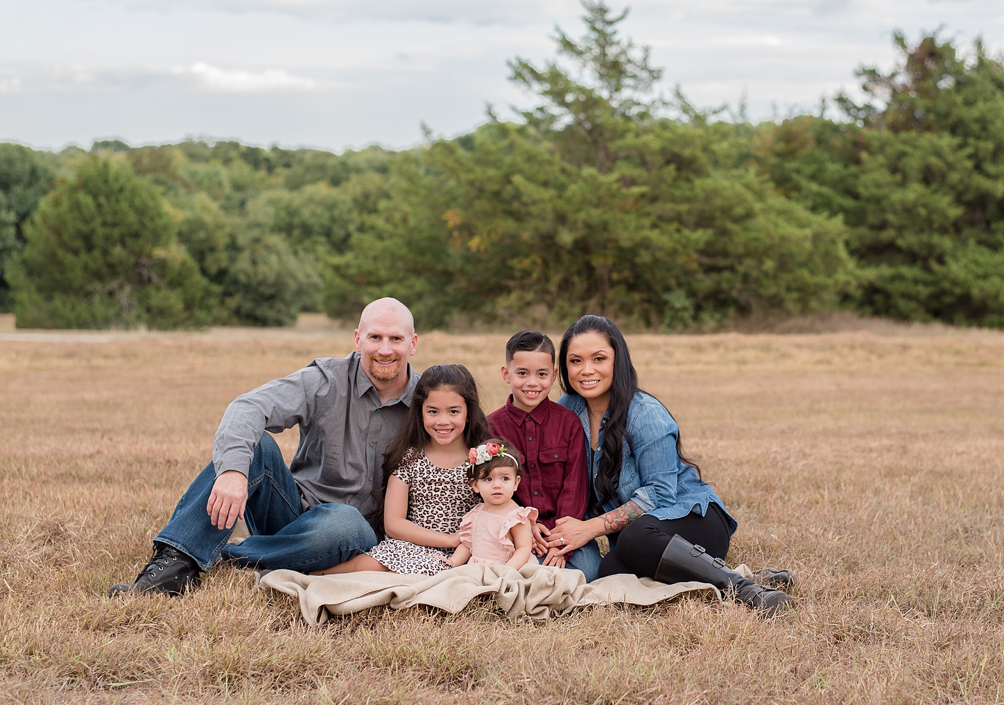 family of five on blanket in grass at family walks together holding hands in Erwin Park during Family Photos