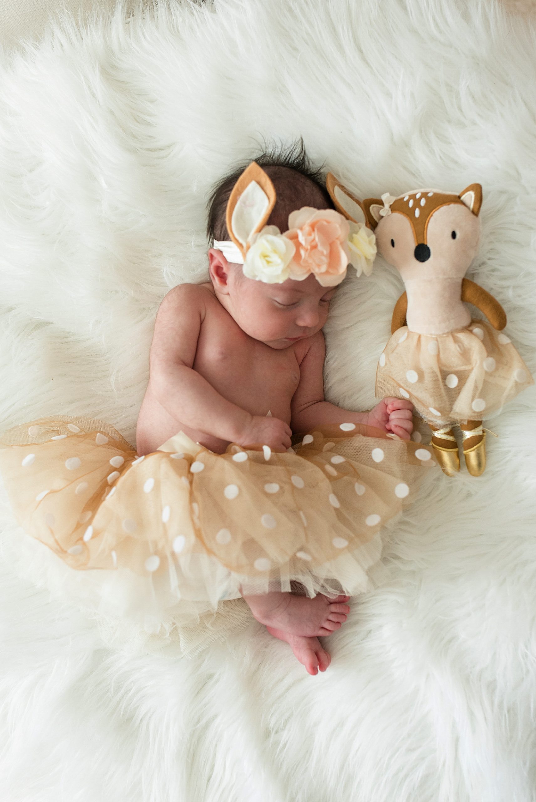 Newborn baby girl in deer outfit with flower crown in pink and white nursery | In-Home Newborn Photo Session | Lindsey Dutton Photography | Dallas Area Family Photographer | newborn session, newborn posing ideas, newborn photos, girl nursery inspiration | via lindseyduttonphotography.com