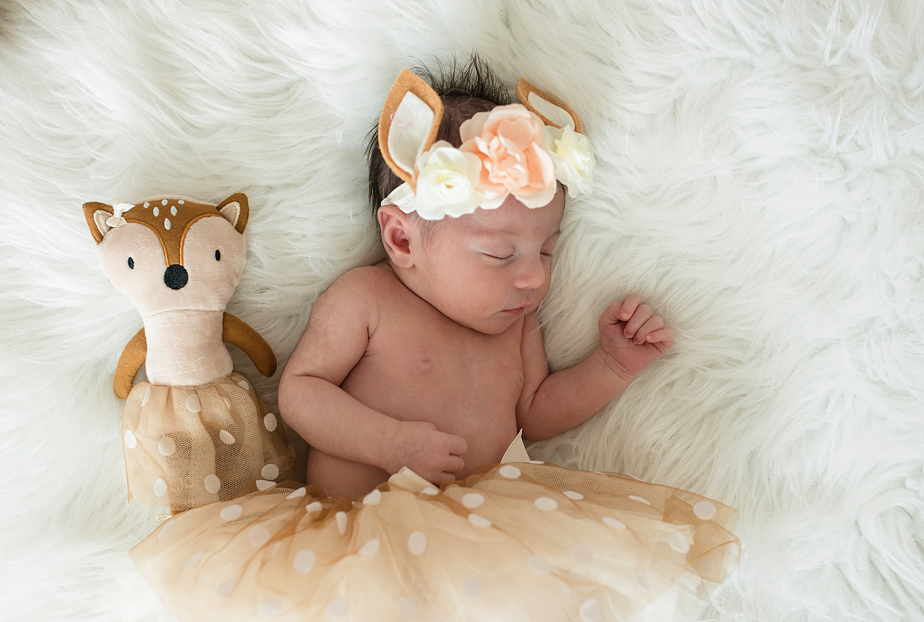 Newborn baby girl in deer outfit with flower crown in pink and white nursery | In-Home Newborn Photo Session | Lindsey Dutton Photography | Dallas Area Family Photographer | newborn session, newborn posing ideas, newborn photos, girl nursery inspiration | via lindseyduttonphotography.com
