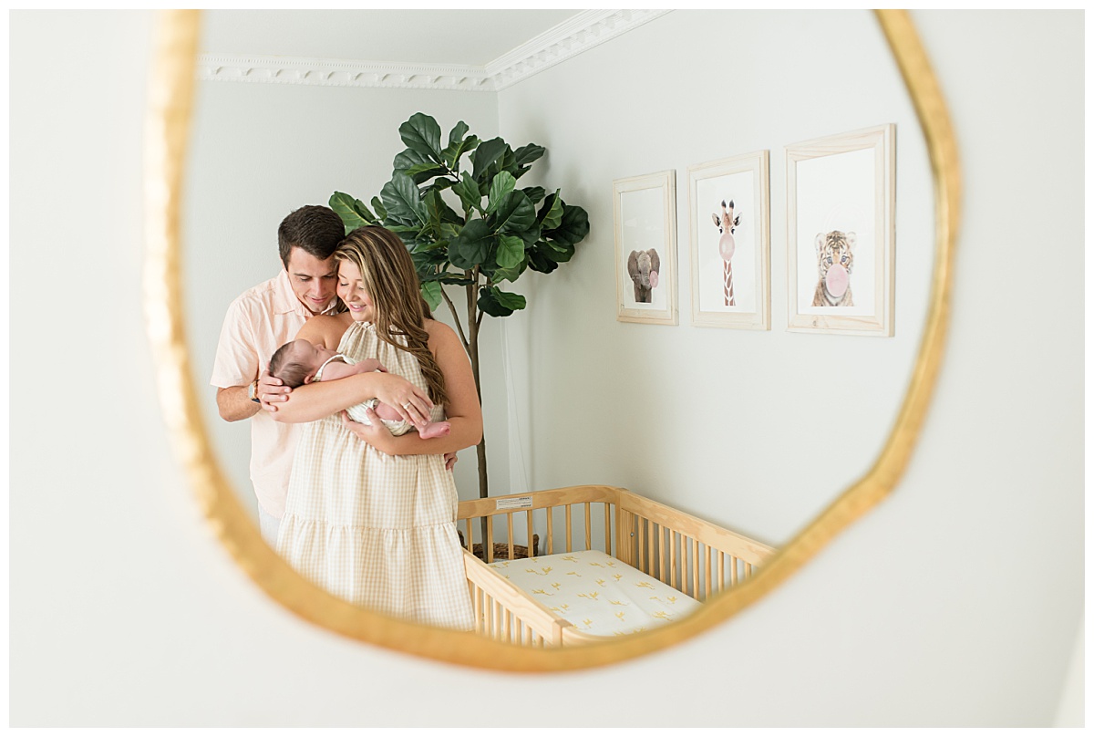 Family at an in-home lifestyle newborn session snuggling in a mirror. Photographed by Dallas newborn photographer Lindsey Dutton Photography