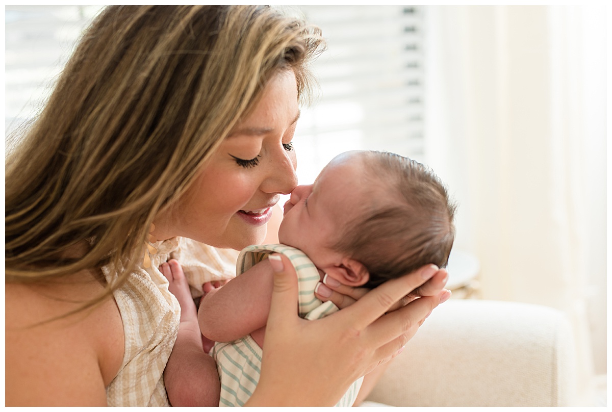 Mom snuggling baby during a lifestyle newborn photo session. Photographed by Dallas newborn photographer Lindsey Dutton Photography